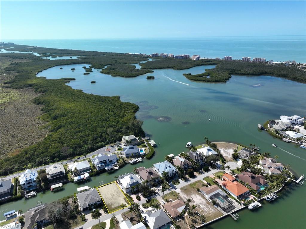 This Little Hickory Shores waterfront lot offers the perfect opportunity to build your dream home including: the only South facing lot in Little Hickory Shores available and it will provide all day sun on your pool and light throughout your new home, existing 10,000 boat dock & davits, seawall are in place for premier boating with 10 minute gulf access with no bridges (boat dock can also be enlarged to accommodate a larger boat), walk or bike to the beautiful beaches of Barefoot Beach and Bonita Beach, no HOA so no fees, low impact fees because of previous home, bay views and winter sunsets as you look to the southwest, and one of Collier County’s most desirable location on a quiet street that is close to shopping, dining, golfing , entertainment and the airport. Examples of potential homes are available for review.
