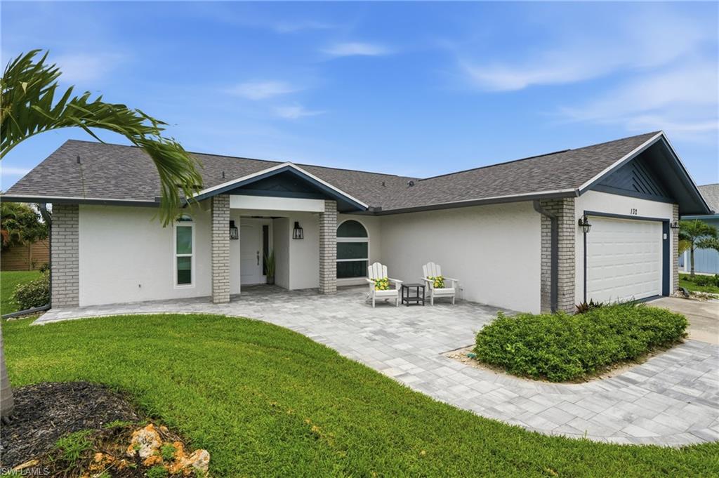 Completely updated open-concept home with desirable ONE-FLOOR LIVING! This 3-bedroom, 2-bath residence features SPLIT BEDROOMS with the primary suite and guest bedrooms located on opposite sides of the home for added privacy. The primary suite includes a private bath and French doors to the lanai. The first guest bedroom offers a queen-size bed and TV, while the second guest bedroom features a Murphy bed and TV, making it ideal as an office, fitness room or hobby room as well as space for extra guests. The living area opens directly to the lanai with an oversized glass slider, creating a comfortable indoor-outdoor living experience. Extensive updates include a new roof with 50 year shingles, skylights, solar panels (electric bills typically range from a credit to approximately $30 per month), impact-resistant windows, doors and garage door, A/C system, front and rear paver patios with walkway around the side of the house, updated lighting fixtures, remodeled kitchen, two remodeled bathrooms, sprinkler system, and whole-house water filtration system. ENERGY EFFICIENT! Annual HOMEOWNERS INSURANCE AT $2400 with all of these updates. Move-in ready. Community amenities include pickleball and tennis courts, bocce, shuffleboard, a large community pool with a massive tiki hut for shade, and fitness center. Conveniently located just minutes from Downtown Naples, 5th Avenue South, fine dining, shopping, and Gulf beaches. LOWEST HOA AT $433/QUARTER! At least one owner must be 55 years of age or older per community regulations. Fantastic opportunity!