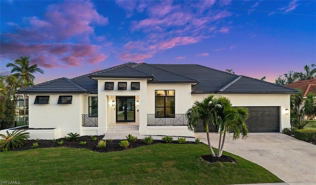 This newly listed residence boasts a fresh, modern aesthetic achieved through recent renovations, with 2,402 square feet of living space and a 3 car garage plus a new roof in 2018.

With 4 spacious and coastal-themed bedrooms and 3 well-appointed bathrooms, this open-concept home is ideal for entertaining and hosting. The heart of the home seamlessly connects the living areas with breathtaking tropical views through every room. Electric hurricane shutters for convenience allow full protection for the home (one manual shutter). Expansive lanai with heated pool and spa invite you to unwind while enjoying the serenity of the oversized lot and deep water views, with 137' of wide waterfront, new seawall, new oversized dock, and equipped with a high-capacity boat lift & jet ski lift. Quick and convenient waterfront access within minutes of Tigertail Beach and Marco dining and shopping.