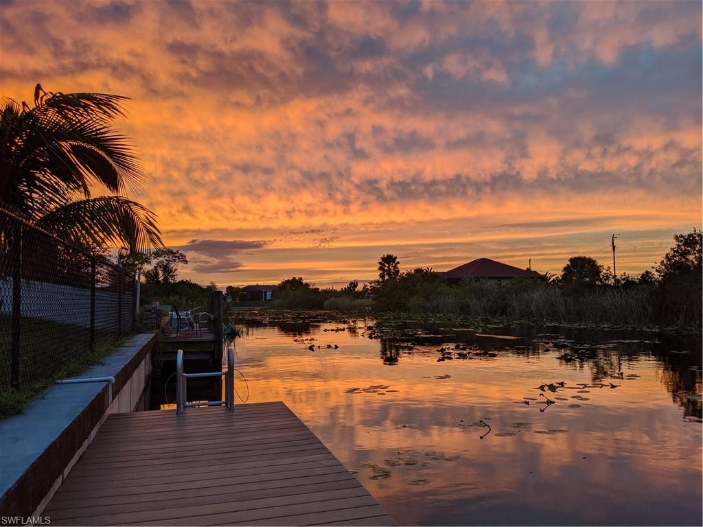 Gorgeous 4 bedroom 2 bath waterfront pool home in beautiful family friendly neighborhood of NW Cape Coral.  This spacious home, with over 2400 sq feet, is perfect for your family.  Bedrooms all have large walk in closets! Huge heated pool, newly fenced in backyard, brand new boat dock to enjoy feeding the turtles and watching sunsets, and a butterfly garden on the side of the home. The homes exterior was recently painted and professionally landscaped.  The canal system is one of the largest freshwater systems in Cape Coral with several lakes and miles and miles of boating.