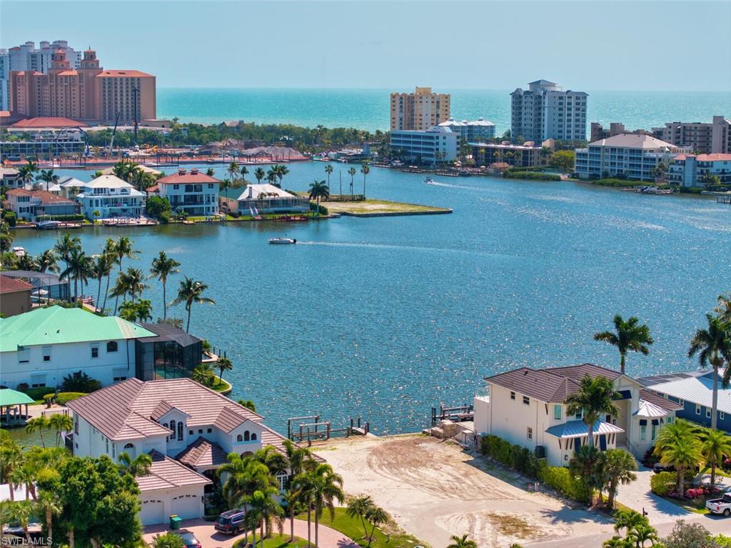 Experience the very best of coastal Naples living from this southern-facing lot overlooking the tranquil waters of Vanderbilt Lagoon. This rare property offers the perfect blend of sun-soaked exposure, wide water views, and a lifestyle defined by leisure and luxury. Wake up to gentle Gulf breezes and watch the sun dance across the water from your private dock. With direct access to the Gulf of Mexico, boating and sunset cruises are just moments away. Whether you envision a contemporary coastal masterpiece or a timeless Florida retreat, this property provides the ideal canvas to bring your dream home to life. Located just minutes from Vanderbilt Beach, The Ritz-Carlton, and the fine dining and shops of Mercato, this address places you in the heart of Naples’ most desirable amenities while still offering a peaceful waterfront escape. Current home being shown is the Bayview Floor Plan with over 3,000 sq feet, 4 bedrooms, 3 and a half baths for $2,950,000 build price for a new home on the water for an "all in" price of under $6M.