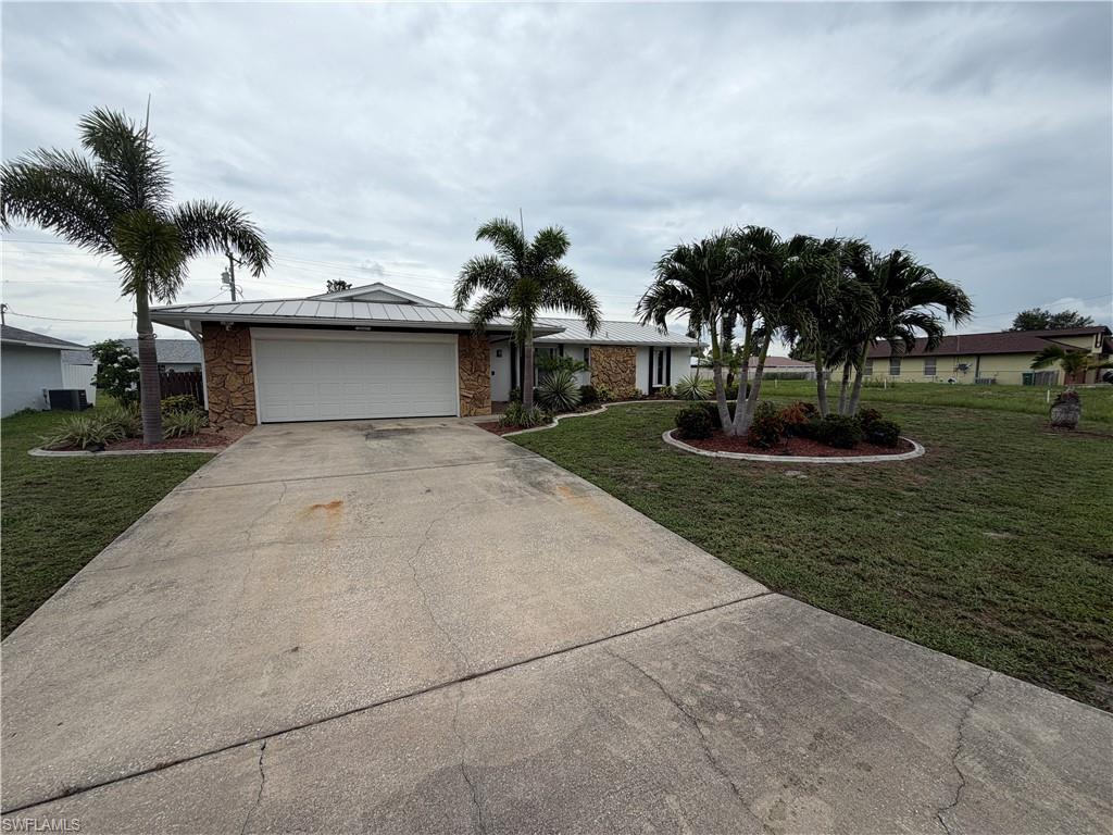 Available Now! Updated 4 Bedroom (or 3 Bedroom + Den) Fenced in Yard Home in SE Cape Coral. Welcome to 2121 SE 1st Terrace, a beautifully updated and move-in ready home offering 1,862 square feet of living space in one of Cape Coral's most convenient and established neighborhoods. This versatile floor plan features 3 bedrooms plus a den that can easily serve as a 4th bedroom, home office, playroom, or flex space, along with 2 full bathrooms and spacious living areas designed for comfortable everyday living. The updated interior showcases attractive stainless-steel appliances, fresh neutral colors, modern fixtures, and an open layout filled with natural light. The kitchen is a standout feature with granite countertops, stainless steel appliances, abundant cabinetry, and a large center island that opens seamlessly to the dining and living areas—perfect for entertaining or family gatherings. The primary suite offers plenty of space and privacy, while the additional bedrooms provide flexibility for families, guests, or remote work needs. Step outside and enjoy the oversized, fully fenced backyard with mature tropical landscaping and plenty of room for outdoor activities, gardening, or entertaining. The home also features a durable metal roof, two-car garage, and excellent curb appeal with beautiful palm trees and professional landscaping. Located in the highly desirable Southeast Cape area, you'll be just minutes from shopping, dining, schools, healthcare facilities, parks, bridges to Fort Myers, and all the amenities Southwest Florida has to offer.