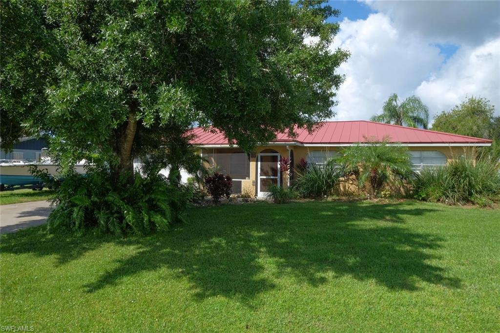 Tired of the hustle and bustle of Central Fort Myers?  Come home to a peaceful country setting ... yet just minutes from I-75!  Nicely updated 3 BR 2 Bath home on a well-landscaped .35 ac lot.  Large FENCED YARD with POOL * custom 1,000 sf Paver PATIO ** great 20x16 storage shed for gardening & pool equipment!  The interior is well-maintained and boasts all newer 16x16 tile throughout ** abundant 42" cabinets in Kitchen plus stainless-steel appliances, double sink and Recessed lighting ** OVERSIZED Master Suite with Sitting area, WALK-IN Closet, private fully tiled & updated Bath with extra-large Shower (3 sep Shower heads) HUGE laundry room lined with cabinets & counter space plus Utility sink ** Washer & Dryer included. Expansive Family room is complete with almost a full wall of French glass doors leading to the Pool ** Formal Dining room in addition to kitchen Breakfast area!!  Bedroom closets with CUSTOM SHELVING.  NEWER A/C (2014) and METAL ROOF!  Property is on a no-thru cul-de-sac street ** North side of the Caloosahatchee River ** BOAT Ramp just 1 mile away at Franklin Lock Rd or Telegraph Creek ** Less than 1 hr to white sand Beaches ** Property is NOT in a Flood Zone!