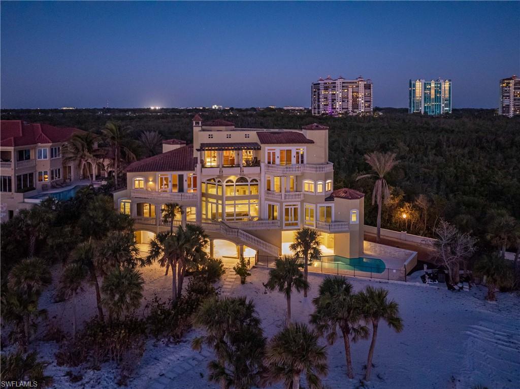 This unparalleled coastal luxury at 7425 Bay Colony Drive, an exclusive beachfront residence within the double-gated Strand at the Colony of Pelican Bay. As one of only eleven homes in this prestigious enclave, it offers over 9,000 square feet of refined living space, including a den, five bedrooms, and seven and a half bathrooms. Designed to maximize natural light and panoramic Gulf of Mexico views, the home's southward orientation ensures sunlit elegance throughout along with 130 feet of beachfront. Adjacent to a serene preserve, it provides uninterrupted natural vistas, fostering a profound connection with the surrounding landscape. Residents enjoy access to a private beach club and the world-class Ritz Carlton, enhancing an already luxurious lifestyle. This property epitomizes the pinnacle of coastal living, combining prime location, exclusivity, and top-tier amenities into a singular seaside sanctuary.