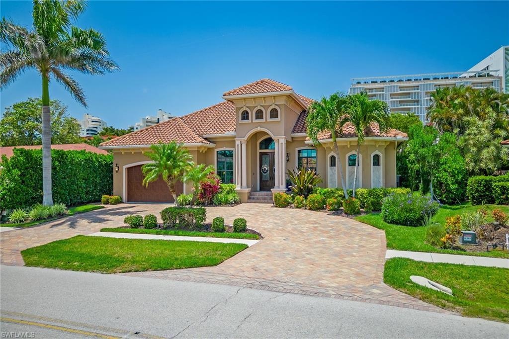 A stunning coastal haven in sought-after Marco Island, this three-bedroom, three-bath luxury residence with a den offers an unparalleled living experience. The beautiful landscaping and stately double-door entry set the tone for what awaits inside. This open concept home features soaring ceilings, oversized windows and doors, crown molding, plantation shutters and designer finishes throughout. The gourmet kitchen boasts stainless steel appliances, custom cabinetry and an expansive center island with seating. The adjacent dining and living room provide an abundance of natural light through large impact-resistant glass sliders, opening to the outdoor oasis. The primary suite is complete with two large walk-in closets with built-ins and a spa-like en suite featuring dual vanities, walk-in shower and jetted tub. Two additional bedrooms with walk-in closets are equally spacious for family and guests, while an office with built-in desk and cabinets offers a serene work environment. The crown jewel is the outdoor living area featuring a covered, screened-in lanai, fully equipped outdoor kitchen with gas grill, and a heated pool and spa. Just minutes from beaches, golf, dining and shopping.