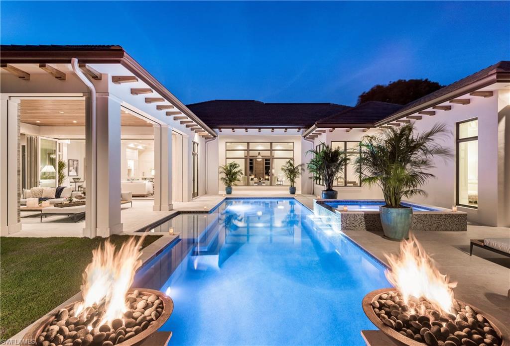 Exceptional New Estate home just completed in Pelican Bay. This spacious, open concept floor plan features 3 living areas with floor to ceiling windows, wide plank washed oak floors, stone and wood trim throughout. The stunning Great Room with glass wall overlooks the 45’ lap pool and 8’ spa nestled in a tropical, completely private and lushly landscaped backyard. The kitchen and family room flow effortlessly into an equally impressive adjoining outdoor Great Room complete with automated screens, shutters, fireplace, TV, outdoor kitchen and dining. Enjoy the spacious, well-appointed kitchen with custom cabinetry, 126” island, Butler’s pantry, Wolf, Subzero and Bosch appliances. Private Master Retreat features a stunning master bath with custom floor to ceiling cabinetry, soaking tub, beautifully tiled glass enclosed shower and 2 water closets. Guests will appreciate 3 en-suite bedrooms. You will appreciate the quality construction and attention to detail. 3 car garage, private office, lighting control, wine refrigerator, wet bar. 3 miles of beach, 2 beach clubs, 4 restaurants, 27 holes of golf, tennis, kayaking and fitness center. Walk to Beaches, Waterside, Artis-Naples.