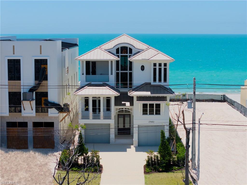 27450 Hickory Blvd offers a rare opportunity to step into newly completed beachfront construction on Bonita Beach—without the years typically required to create it. The residence spans nearly 6,100 square feet under air, with six full ensuite bedrooms, a dedicated office/flex room, and two additional powder baths. The floor plan is designed to live well. Open where it should be, private where it matters, and capable of handling a full house without ever feeling crowded. The main living area centers on the Gulf, where walls of glass disappear, and the horizon becomes part of the room. It’s an easy place to sit down, look out, and realize you’ve reached a point where you know exactly what matters—and more importantly, what doesn’t. Then you look back and see your family and friends enjoying it with you—and that’s what makes it all worth it. Interior finishes are warm and grounded, with deeper wood tones and natural materials that bring a sense of familiarity and permanence. It’s refined without being formal, substantial without being heavy. Outdoor living is seamlessly integrated, with a pool and spa set directly along the Gulf, an outdoor living room, a fully equipped kitchen, and balconies positioned to take advantage of both warm sunrises over the mangroves and watercolor sunsets that slowly melt into the stars. Built by Potter Homes—one of the most established builders on Bonita Beach—this is a home backed by a track record of storm-tested construction and long-standing client relationships. Control4 automation integrates audio, lighting, shades, storm protection, and climate throughout the home, designed to function simply, whether you’re in residence or away. This is a home for someone who values peace over noise, restoration over endless activity, and permanence over trend. A place to come back to—year after year—with the same people, to make the memories that truly matter most.