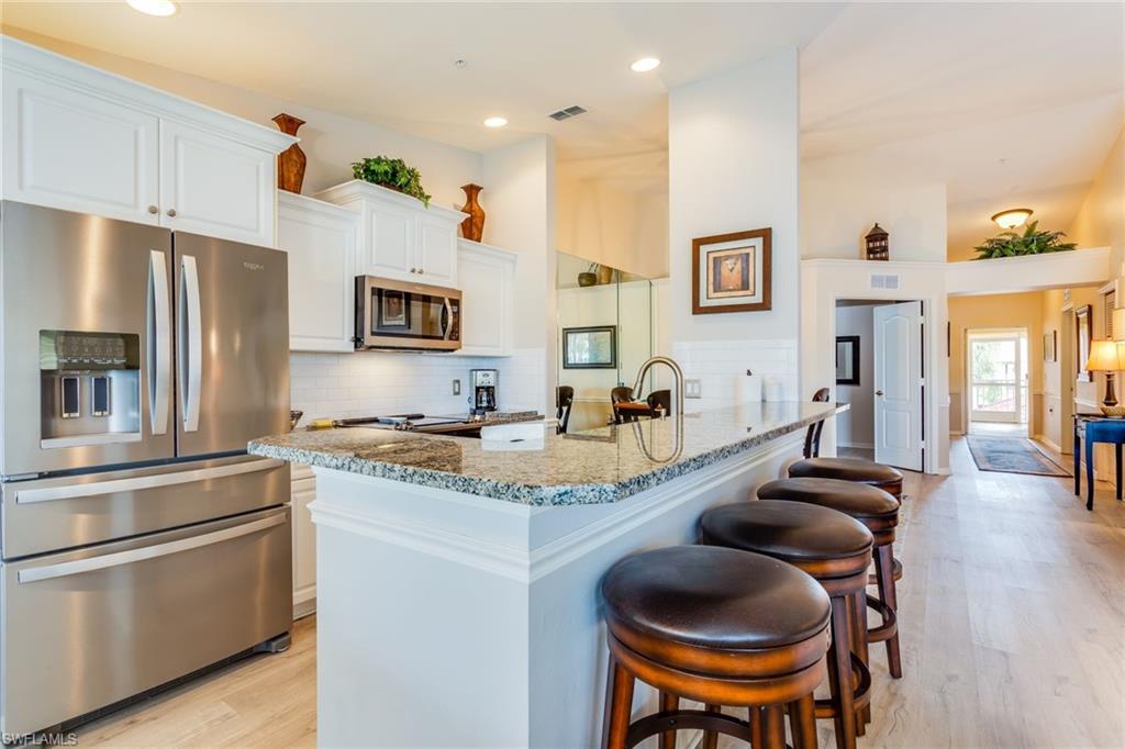 Stop looking, THIS IS THE ONE! This immaculate home has a beautifully updated eat-in kitchen with granite & top-of-the-line Whirlpool stainless-steel appliances. The sought after layout features the family room & kitchen in the back with expansive lake views and vaulted ceilings. The den features custom built-ins making it an ideal office space plus a queen-size Murphy bed when you need extra sleeping quarters. The 2nd bedroom also features custom built-ins & plantation shutters which you'll find throughout the home. The master bedroom has a large, walk-in closet & en-suite with dual sinks & lots of cabinet space. The home's garage will keep your car protected from the Florida sun and offers extra storage for your golf clubs, beach chairs, bicycles, and more. Cypress Trace boasts 3 pools & spas and, of course, all of the amenities of The Cypress Woods Golf and Country Club, including restaurant & bar, large heated community pool, lap pool, spa, 4 lighted tennis courts, fitness facilities & too many more to list. BEST OF ALL, this is a bundled golf community with a championship 18-hole course designed by Gordon G Lewis - golf membership is included with your new home!