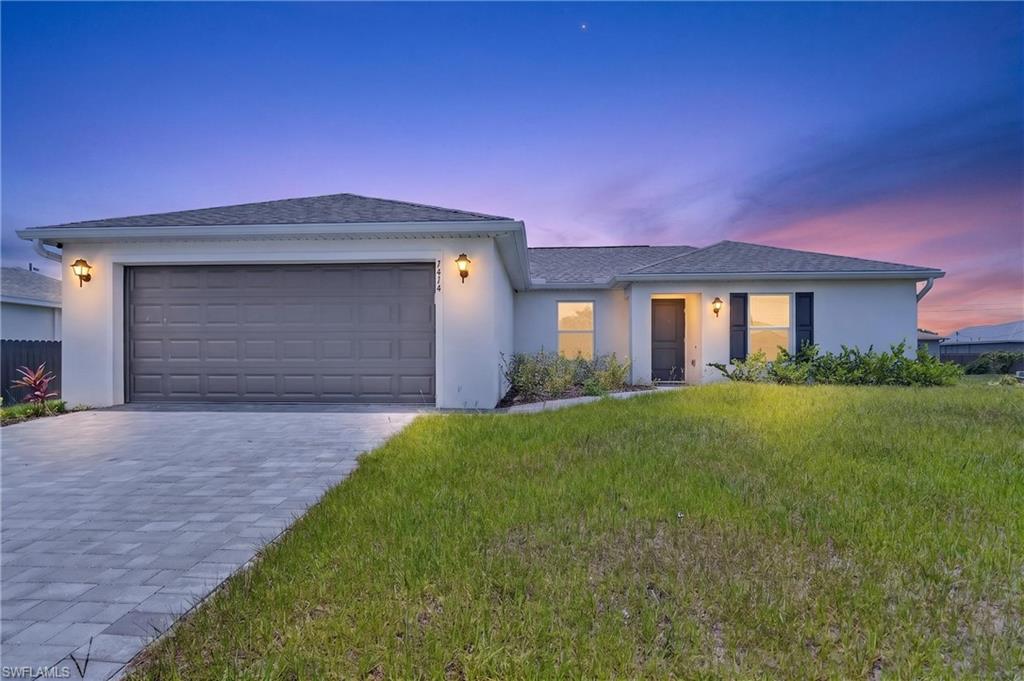 2025-built Bristol plan by Coaston Homes offering 3 bedrooms, 2 bathrooms, a 2-car garage, and 1,240 square feet of smart, efficient living space on a generous .23-acre lot. This home has everything new construction promises — and then some. Window coverings, ceiling fans, upgraded lighting fixtures, and landscaping are all already in place, giving this home a finished, move-in-ready feel that freshly built homes rarely deliver without significant additional investment.
Step inside to an open great room floor plan, soaring vaulted ceilings, and beautiful tile-plank flooring throughout the main living areas. The kitchen features 30-inch contemporary shaker-style cabinetry, a spacious center island with upgraded countertops, and a full Whirlpool appliance package including dishwasher, microwave, range, and refrigerator. The kitchen overlooks the great room, keeping the layout open, connected, and easy to live in every day. The split floor plan gives everyone their own space. The owner's suite is privately positioned on one side of the home, featuring a large walk-in closet, a dedicated linen closet, and a private en-suite bathroom. The two guest bedrooms occupy the opposite wing and share a well-appointed full bath — ideal for families, a home office setup that still leaves a true guest room available. What truly sets this property apart is that the adjacent lot is privately owned by the neighboring homeowner and is beautifully landscaped — creating a park-like green space directly beside your property. Fewer neighbors. More breathing room. A natural buffer! 
The exterior delivers the curb appeal new construction should. A decorative brick paver driveway, landscaping with irrigation, and designer-selected paint colors and fixtures give this home a polished presentation from the street. Impact-resistant windows and doors are throughout — delivering storm protection, potential insurance savings, and lasting peace of mind. An open lanai off the rear. No HOA dues.
The location puts you in Cape Coral's growing north corridor, close to shopping, dining, and services along Pine Island Road, with public boat ramps, Matlacha, and Pine Island accessible nearby. The future of this corridor is exceptional — the Seven Islands Project, approved 7–0 by City Council in January 2026, will bring a Marriott-branded hotel, waterfront restaurants, a public marina, and a lagoon resort to nearby Old Burnt Store Road. Cape Coral Grove, a 131-acre mixed-use town center on SW Pine Island Road, is projected to generate over $1.3 billion in economic impact, bringing retail, dining, parks, and residential options that will only strengthen the value of homes in this area for years to come.
2025 built. Virtually new. Upgrades already done — window coverings, fans, lighting, landscaping all included. Park-like lot next door for rare added privacy. All appliances plus washer and dryer. Impact windows. No HOA. This is the smarter buy.