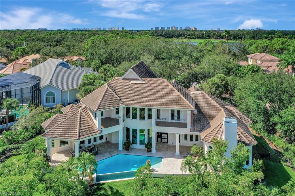 H12004. Architectural Showstopper in Audubon Sanctuary! Tucked away off a quiet cul-de-sac, this French Country-style Manor is the perfect escape from the ordinary. Affording the privacy of a 27,000 SF (0.62 acre) site, the residence was commissioned for a 4-BR+Den plan complemented by expansive outdoors w/ 226 ft. nestling against a nature preserve. The open-concept interior is flooded with natural light showcasing remarkable architectural elements, from walls of tall nature-reflecting windows to soaring ceilings w/ exquisite coffered & tray ceiling detail. Luxury amenities include a 500-bottle climate-controlled wine room; butler's pantry; gas fireplace; and wood-paneled elevator to the upper-level. The fabulous owner's suite w/ French doors to the lanai features a light-filled retreat, two XL walk-in wardrobes and a gorgeous marble bath. A chef's delight is the island kitchen incl. gas cooktop, double wall ovens, a walk-in pantry & ample granite-topped custom cabinetry. The renovated negative-edge pool, spa, stone deck & poolside BBQ are pure pleasure to share. An over-sized 2car+golf cart garage, impact windows/doors and a soon-to-be-installed new flat tile roof top it all off.