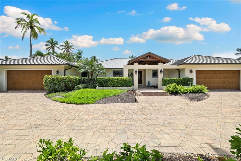 NO WATER INTRUSION FROM PAST STORMS! A 40’ boat slip and 37.5’ of private beach frontage just steps away from your door. The Port Royal Club just 10 houses down on prestigious Gordon Drive. Discover modern living at its finest in this beautifully appointed residence, perfectly nestled in the sought-after Port Royal neighborhood. Boasting nearly 2,755 sqft. of luxury, this one level ranch styled home features four spacious bedrooms plus a study, making it ideal for families or those seeking additional space.

Every modern convenience is at your fingertips, including three elegant bathrooms and a sprawling outdoor living area. Enjoy the ultimate Florida lifestyle with a 40' dock with deeded access on Champney Bay and fractional ownership in private beach access! Regarding to beach lot: This property has 1/6 undivided interest in a 37 1/2’ beachfront lot. The portion of the lot is deeded to the property.

Step outside to find your very own tropical paradise, complete with a summer kitchen, a tongue and groove loggia, and a sparkling pool with a fountain. The grounds are further enhanced by an array of fruit trees, creating a serene and inviting atmosphere for outdoor entertaining.

Inside, sophisticated finishes abound. The gourmet kitchen is equipped with top-tier appliances, perfect for any culinary enthusiast. Pocketing slider doors seamlessly blend the indoor and outdoor spaces, while custom millwork, including stunning ceiling details and linear diffusers, adds an extra layer of elegance.

Residence is finished with a newer roof and the security of impact doors and windows throughout.

Situated among the prestigious estates of Port Royal, this residence also grants eligibility for a Port Royal Club associate membership. Plus, it's just a short distance from Naples' renowned Third Street South and Fifth Avenue South, where you’ll find exquisite dining, shopping, and entertainment options.

Embrace the Naples lifestyle in this extraordinary home—where luxury meets comfort in every corner!