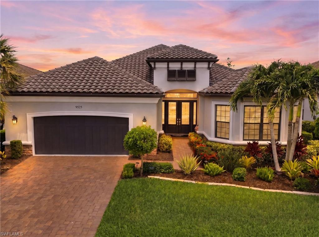 From the moment you step through the double-door entry, it’s clear that 9525 Montelanico Loop is in a league of its own. This meticulously designed 4-bedroom plus den/office residence is a masterclass in custom millwork and sophisticated upgrades, featuring crown molding in every room, elegant beadboard, nickel gap accents, and wainscoting that elevates the dining experience. Durable laminate flooring flows through an open layout that feels both grand and incredibly welcoming. The heart of the home is a chef’s dream, boasting white shaker cabinetry and crisp quartz countertops. In the great room, a custom niche with a stylish backsplash adds a designer touch, while the dedicated office space is a true standout. Work from home in style with custom ceilings and pocket doors that lead to a secondary office space featuring a stunning coffered beam box ceiling. Even the laundry room is a showstopper, oversized with custom cabinets, ample counter space, and a dedicated sink. The primary suite serves as a private sanctuary, complete with a feature wall, plantation shutters, and a spa-like bath. Indulge in the soaking tub or the oversized shower with dual heads, complemented by light gray shaker vanities and quartz tops. Guests will feel equally pampered in the front en suite bedroom, which mirrors the home’s high-end finishes with a walk-in shower and impact glass. Outdoor living reaches new heights on the expansive brick paver lanai and natural gas outdoor fire place. The 17-foot outdoor kitchen is a focal point, featuring marine-grade cabinetry, granite counters and a side burner—all protected by a picture-frame screen for unobstructed views. Relax in the heated saltwater pool and hot tub, surrounded by professional landscaping and ambient lighting that transforms the backyard into a nightly retreat. Built with peace of mind in mind, this home is equipped with full hurricane impact glass, additional hurricane screens, and a generator. Modern conveniences abound, from the extended four-foot garage with a keypad entry to integrated Wi-Fi extensions. This is more than just a home; it’s a lifestyle defined by quality, comfort, and impeccable taste—now made complete with an included golf membership, offering seamless access to world-class amenities right from your doorstep. As a resident of Esplanade Golf & Country Club, you'll enjoy a bundled golf membership providing immediate access to the championship golf course, resort-style pool with cabanas and poolside dining, Day Spa, fitness center, tennis, pickleball, bocce, scenic walking and biking trails, dog park, and a vibrant social calendar with multiple on-site dining venues. Adding even greater value, the seller has paid the community assessment in full, allowing the next owner to enjoy all of these exceptional amenities without the added expense. This is a rare opportunity to own a highly upgraded residence in one of Naples' premier bundled golf communities.