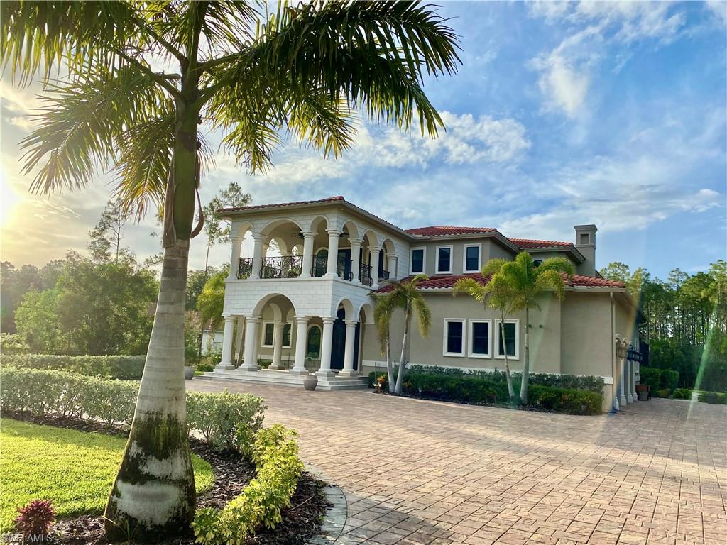 Welcome to this timeless elegant custom built two story transitional estate home situated on 2.5 acres in one of the best lots in Livingston Woods! This home was built to the highest standards with 5 suite sized bedrooms, 5.5 bathrooms, and 3.5 garage bays with extended storage, finished epoxy floors and 3 oversized high lift bays, extensive lanai, 2 laundry rooms, three a/c units, modern gas fireplace, large porcelain tile and wide-plank wood flooring, 12 to 25ft. grand ceilings, custom molding, wolf & subzero appliances, walk in pantry, 3 wet bars with beverage center, an upgraded security system, smart home with CAT 5 wiring and wired speakers, the master retreat includes two custom walk-in master closets, master bath Jacuzzi tub, oversized custom his and her shower with an exercise area. Masterfully designed for Florida living, the interior living spaces blend with the outdoor living areas through glass sliders, French doors, luxurious outdoor kitchen, resort style lap pool with sun shelf and jacuzzi spa that fits 12.  This home is hurricane proof with all impact windows and doors, spray foam insulation throughout and a whole-home generator (1,000 gallon propane tank).
