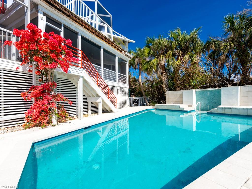Clam Bayou is one of Sanibel's absolute treasures. The quiet, peaceful setting along the bayou is framed by mangroves with the Gulf beyond. Nature is paramount in this part of the island: wildlife abounds in the water, on the shore, and in the air. This gorgeous home sits directly on the bayou. The water views of the bayou and of the Gulf are spectacular. With multiple decks on the south side of the home, there is no shortage of places to enjoy this unbelievable location from the outdoors and with abundant windows, the same is true from the indoor living space. Set back from Sanibel Captiva Road, the front yard is expansive and provides beautiful garden views. The interior of the home is virtually untouched by the storm. All photos are post- storm. The top floor is a huge primary suite with an adjacent sun deck and includes a private office. The living space is lined with windows allowing excellent natural light. The kitchen features a stunning showpiece granite island with complimentary quartz countertops, stainless steel appliances, and a large walk-in pantry. The guest suites are extremely private. The waterfront pool features a dramatic fountain wall. Just spectacular!