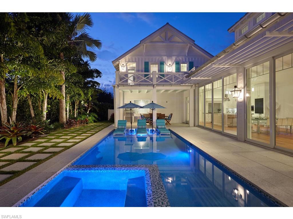 This custom home is the epitome of beauty and grace. Located on one of Old Naples’ most charming streets and just steps to the renowned sugar sand beaches of the Gulf of Mexico, this home is perfect for entertaining. The great room concept features a chef's kitchen that opens to the dining and living space. The timeless architecture is accented with custom landscaping & lighting design, Old Chicago Brick, Zoysia grass, mature palms and a picket fence. The home's interior features include one of a kind reclaimed Heart Pine floors, tongue & groove ceilings, custom millwork, polished nickel fixtures & hardware, top of the line gas & electric appliances, an oversized island with marble countertop, and inset cabinetry. The master suite offers two large walk-in closets, and large master bathroom giving it a spa-like feel. Tall sliding glass doors allow for effortless indoor/outdoor living. The expansive outdoor living space features a large saltwater pool and spa with an outdoor fireplace, dining area, and outdoor kitchen. With an attached three car garage off of an alley and options for two elevators, this home is luxurious Old Naples living at its best!
