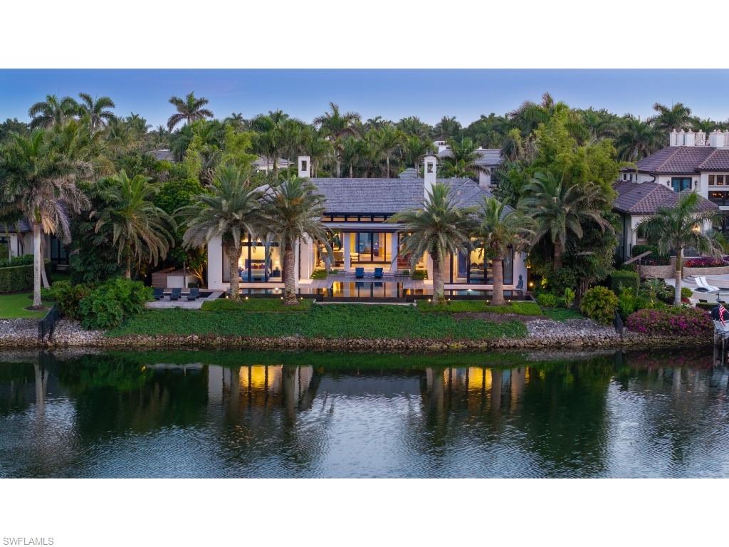 One of the most magnificent residences ever constructed in Port Royal, this exceptional home stands as a true architectural and artistic achievement. Built to exacting standards by renowned builder Newbury North Associates, Inc., and innovatively designed by celebrated architect Mark J. Leonardi Architect, PA, the residence was conceived as an elegant artistic expression, while achieving the highest levels of craftsmanship and design integrity. With stunning, light-filled interiors, refined detailing, and a unique, sophisticated use of materials throughout, the home has quickly become an icon within the Port Royal landscape. Perfectly situated along the tranquil and protected waters of Morgan’s Cove, widely regarded as one of Port Royal’s most desirable settings, the property offers glorious water views and an extraordinary sense of serenity. The architecture is spatially and form-driven, resulting in a residence that is both distinctive in attitude and enduring in relevance, reflecting a regionally modern aesthetic that feels timeless rather than trendy. Often described as a “jewel box,” the home reveals layers of thoughtful design, refined craftsmanship, and bespoke finishes at every turn. The exceptionally private grounds, were masterfully designed to provide a lush and peaceful backdrop that enhances the home’s sense of seclusion while maintaining a strong connection to the waterfront. Despite its tranquil setting, the property enjoys convenient access in and out of the community and is located in close proximity to the amenities of the Port Royal Club. Port Royal Club membership eligibility and the anticipated completion of the brand-new Port Royal Club beach club further enhance the appeal of this legacy property in one of Naples’ most prestigious enclaves.
