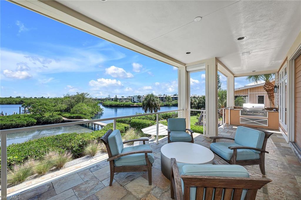 A rear gem on Fort Myers Beach!  Enjoy magical views from the stunning 4 Bedroom Home! As you step into the great room, you are immediately drawn in by the soaring cathedral ceiling and the endless views visible through the 10-foot pocketing sliding glass doors. A wood beam diamond-shaped coffered ceiling with stained tongue-and-groove detailing enhances the luxury kitchen, which is a true chef's dream with gas cooking, extensive storage and a convenient wet bar. Two master suites that open to a second balcony are located on the upper level. Enjoy a built-in desk and private bath in the junior suite while the larger suite includes a double vanity, under-counter fridge, walk-in shower, soaking tub, two walk-in closets, along with a stackable washer and dryer. Your paradise awaits outside with an outdoor kitchen off of the main balcony, an oversized pool spa and fireplace on the lower level, along with a private boat slip and lift.  This home is a must-see.