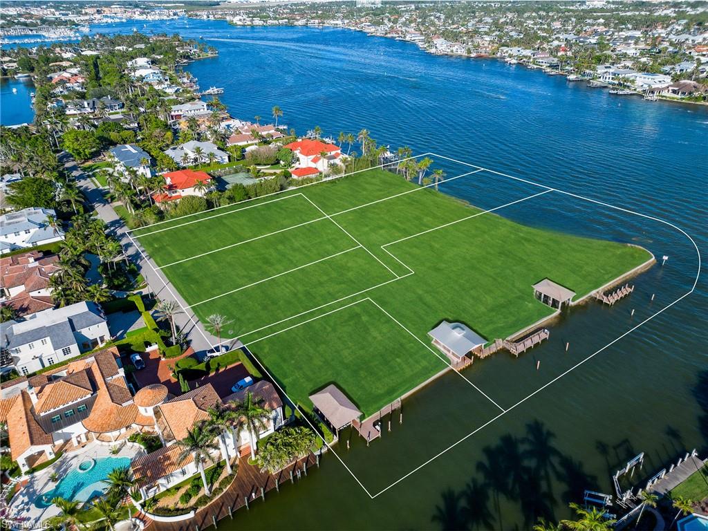 A once-in-a-generation opportunity in the heart of Aqualane Shores.
Encompassing nearly 4 acres across 7 contiguous lots, this extraordinary waterfront assemblage offers an unmatched 858 feet of continuous water frontage along a deepwater canal and Naples Bay. A true rarity in Naples, it combines panoramic bay views, direct Gulf access with no bridges, and three grandfathered-in boathouses - making it both a boater’s paradise and a developer’s dream. The site is nearly cleared and ready for transformation, presenting the perfect canvas for a world-class private compound or multiple luxury estates. Situated just moments from the beach and Naples’ iconic Third Street South, this is among the largest and most significant land offerings ever presented in Aqualane Shores. A legacy property of rare scale and potential.