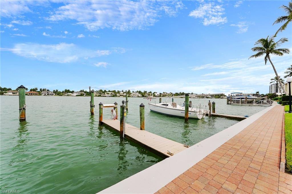 Once you walk into this one of a kind 1,240 sq ft Turnkey Condo, you look right out onto Mooring's Bay through the Big Bay Sliding doors you will instantly fall in love! This Condo comes fully Furnished with Jenn-air High- end Stainless Steel Appliances, Whirlpool Front Load Washer & Dryer and a Bar in the lanai to entertain. Granite Countertops throughout, Big Porcelain tile floors in the living area along with crown moulding, wood floors in the master bedroom, Custom Bay window Shades and Plantation Shutters in the bedroom. Also if you're having company a futon that sleeps 2 in the living area. Deepwater, Direct access Docks Available to the Gulf of Mexico! " No Bridges to the Gulf " perfect for large boats and Sailboats, also a Floating Dock. Beach access right across the street to Miramar Beach! Also, a beautiful saltwater pool overlooking Moorings Bay. Relax and enjoy the one of a kind views! Start off the day on the dock of the bay enjoying the frequent passer buyers! Dolphins, Pelicans, manatee's, and Much Much Much More! This Beautiful First Floor Condo is surrounded by Impeccable maintained and upgraded grounds! Don't miss out on one of the most exclusive areas in SW FL!