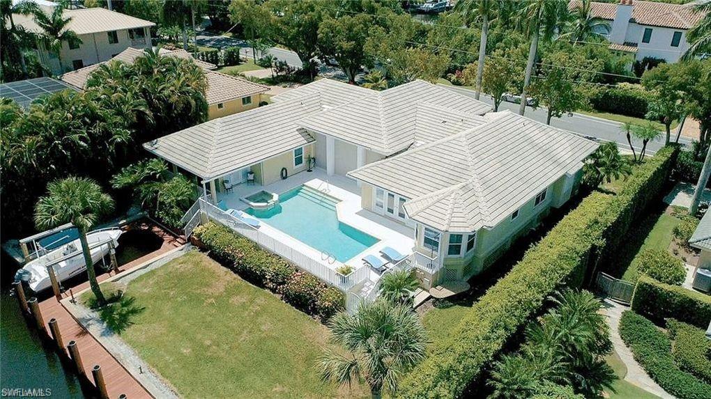 This bright, airy, and charming home is a waterfront living dream on Duck Canal in Aqualane Shores. Park your boat in your backyard that includes a 63' boat dock and additional boat slip with hoist. This Naples Island retreat boasts a color palette of sand, surf, rich woods, & plantation shutters throughout. Master bedroom opens to a private screened porch & enjoys all that living on the water in Naples offers. Large sunny pool, spa and deck include covered loggia with an electric screen enclosure and completes this five-bedroom, three bath residence. White sand beaches on the Gulf of Mexico awaits, Historic 3rd Avenue, 5th Avenue shopping and dining are all a short walk or bike ride away. This is beyond your desirable location in Naples, FL and this home has the potential and inherent charm to be your Florida dream home! Endless possibilities!