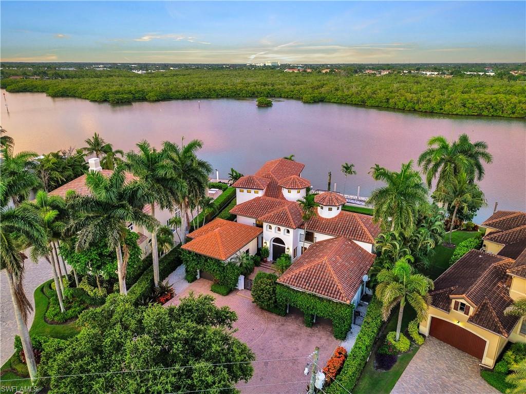 Welcome to waterfront living in the heart of Royal Harbor. Perfectly positioned on a desirable deep-water canal with direct Gulf access and no bridges to the Gulf, this custom-built Andalusian-style masterpiece, inspired by southern Spain's architecture, showcases elegant courtyards, fountains, intricate ironwork, and rich architectural details. The residence offers the ideal blend of luxury, comfort, and the ultimate Naples boating lifestyle.
Designed for both everyday living and entertaining, the home features approximately 3,653 square feet under air, four spacious en-suite bedrooms, including a luxurious first-floor primary suite, a private office/den, and multiple indoor and outdoor gathering spaces. Expansive glass doors and windows fill the home with natural light while framing beautiful long-water views.

Boating enthusiasts will appreciate the property's exceptional waterfront amenities, including a 98-foot dock that accommodates vessels up to approximately 80 feet, providing easy access to Naples Bay and the Gulf within minutes. A unique one-car garage equipped with a vehicle lift provides two-car storage capacity, creating additional flexibility for luxury vehicles, golf carts, watercraft equipment, or seasonal toys—perfectly complementing the waterfront lifestyle.

The outdoor living area is designed to maximize Southwest Florida living, featuring a spacious covered lanai, resort-style pool and spa, and multiple areas for relaxing, dining, and enjoying the tranquil waterfront setting.
Located just minutes from downtown Naples, including Fifth Avenue South and Third Street South, as well as world-class dining, shopping, and Naples' white-sand beaches, this property offers a rare opportunity to enjoy one of Naples' most coveted waterfront neighborhoods.

Whether you're seeking a full-time residence, seasonal retreat, or premier waterfront investment, 2535 Tarpon Road delivers the privacy, luxury, and boating lifestyle that defines Naples’ waterfront living.