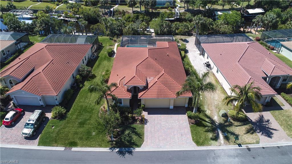 Affordable luxury WATERFRONT living in Historic Fort Myers, "The City of Palms." This pristine home was lovingly cared for and is move-in ready! This spacious Hawthorne model is a split plan with a gourmet kitchen and great room for entertaining that flows seamlessly with triple sliders to the large paver lanai and heated salt water pool with lounging platform. The lush backyard has a private dock and boat lift that allows you to keep your boat completely out of the water and can accommodate various boat sizes. The canal leads to the Caloosahatchee River and out to both the Gulf and cross state to the Atlantic Ocean. This is the life! Travel by boat to fabulous shopping, dinner and cocktails daily. This home has water resistant bamboo flooring, upgraded SW interior paint, 42" cabinetry, granite and all bedrooms have a private bath. The leaded glass entry door and abundance of windows give this home a light, cheery coastal feel. This well-built home has a 3-car garage, tile roof, block construction and comes with new clear storm shutters for added safety during storm season. You'll love the resort style pool, tennis, playground and more all surrounded by tropical foliage!
