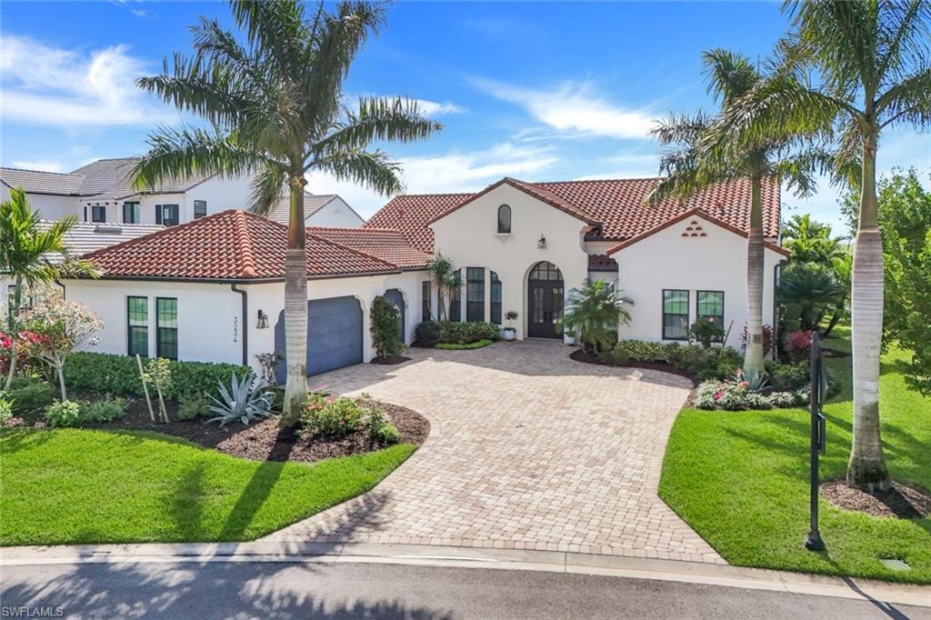 A RARE riverfront GEM with tranquil preserve, sunset views and no neighbor to one side offers unmatched privacy and natural beauty. This Stunning Santa Barbara-Style Masterpiece has Luxurious Finishes and is Highly upgraded.   When you walk through the double heavy metal doors and through the arched foyer you are met with 12- and 14-foot beamed and shiplapped ceilings, small artfully placed LED lights and chandeliers illuminates the stunning upgraded marble flooring. Rich hardwood floors in all bedrooms add warmth and contrast, while the neutral color palette creates a serene ambiance. This renovated Kitchen has a unique T-shaped island, crafted with extra-thick Taj Mahal quartzite and a striking three-sided waterfall design, Custom European automatic cabinetry with pull-outs for appliances, a farm sink, ice maker, a gas range, Jenn-Air custom refrigerator and a built in prep area complete this dream kitchen. The adjacent dining area boasts 12-foot beamed ceilings and sliding glass doors, inviting you to step into the expansive outdoor living space. Pocketing sliding doors lead to the outdoor lanai which is a true entertainer’s paradise, where there are no worries about bug bites with the upgraded tight weave screens.  Relax by the oversized saltwater pool and spa, featuring a cascading waterfall, color-changing LED lights, and breathtaking lake and preserve views. The extra-large lanai provides ample space for dining and lounging.  A custom walk in wine closet with built-in shelving and designer lighting offers a sophisticated space for your collection. The primary suite is a private sanctuary, featuring multiple windows overlooking the serene preserve, hardwood flooring, and a luxurious dressing area. The spa-like bathroom is equipped with his-and-hers marble waterfall vanities, LED mirrors, touchless faucets, a soaking tub, and a double walk-in shower. The custom-designed walk-in closet is nothing short of spectacular, offering ample space and impeccable organization. All bedrooms are en suite, providing ultimate privacy and comfort for family and guests alike. Additional upgrades include Air conditioned garage, Whole Home Generator, Storm Smart Shutters, Large safe, Built in Garage storage, highly upgraded storage and cabinetry in the laundry room and Hunter Douglas Blinds throughout. You have the option of putting in your own private boat dock in your backyard and enjoy fishing steps from your home.This one-of-a-kind home blends timeless elegance with contemporary luxury. Fiddlers Creek offers a Beach Club, Boating Club and Golf. An immediate golf membership is available to purchase at the Fiddlers Creek Golf and Country Club with 100% equity, fully refundable—enhancing the lifestyle that awaits in this premier Naples address. Come experience timeless luxury just minutes from Marco Island and Naples 5th Avenue. .Schedule your private showing today and experience it for yourself! Low Transferable Flood Insurance! CDD is PAID!