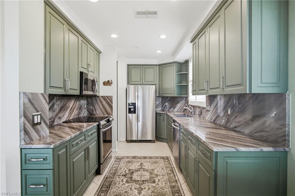 Incredible golf course and water views await you at 3960 Deer Crossing Ct., Unit 101. Overlooking the 13th and 14th holes of the Rookery Course, this beautifully positioned first-floor end-unit condominium offers a serene setting with desirable southern exposure and abundant natural light throughout. Located in the sought-after Deer Crossing neighborhood of Fiddler's Creek, this residence combines comfort, space, and picturesque views from the relaxing screened lanai. Once inside, you will enjoy the tastefully renovated kitchen featuring lovely green hues, soft-close cabinetry with pull-out shelves, newer appliances, updated fixtures, and more. Both bathrooms have also been thoughtfully renovated. Additional highlights include plantation shutters throughout, brand NEW dishwasher and sink disposal (June 2026), fresh paint in primary bedroom and all bedroom closets, a NEW tankless water heater (2025), newer roof (2024), newer lanai screens, and an attached 2-car garage. The property is equipped with electric hurricane shutters, providing added peace of mind and convenience. Whether you're looking for the perfect seasonal retreat or a year-round home sweet home, this residence with exquisite views is sure to make you feel at home. Residents of Fiddler's Creek enjoy a premier resort-style lifestyle with a location in between Naples and Marco Island. The award-winning community features resort pools and spa, a fitness center, pickleball and tennis courts, a 54,000-square-foot clubhouse, casual dining at The Gator Grill and fine dining at Caxambas at the club. Optional golf and beach memberships are also available, which offer endless opportunities to enjoy Southwest Florida living!