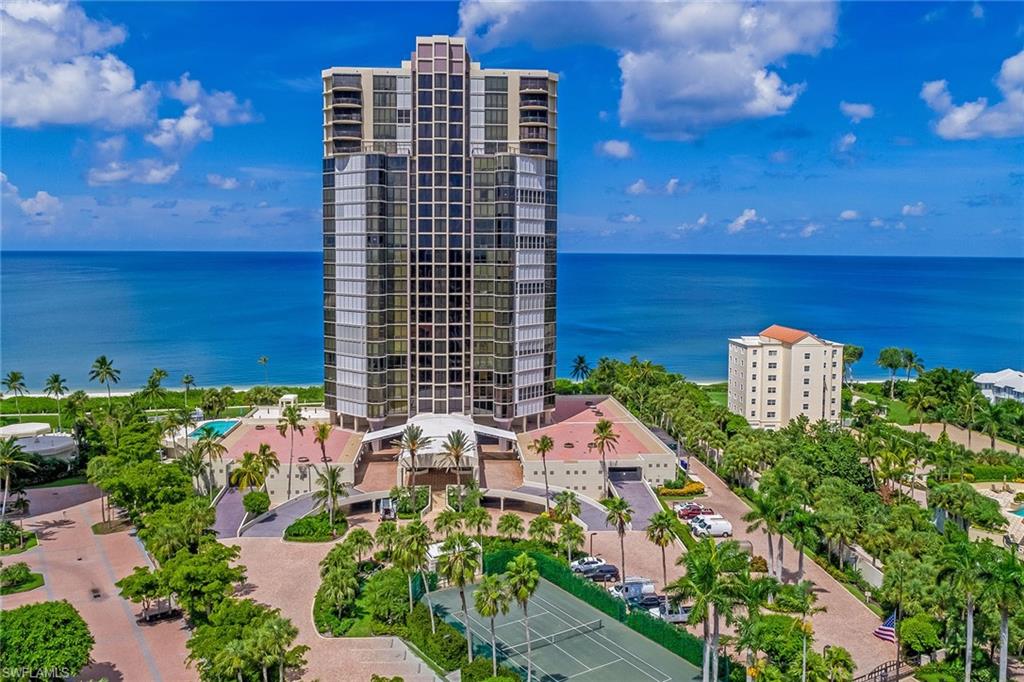 Unparalleled location and view. Welcome to beach and Gulf-front living at the prestigious Le Parc community in Park Shore. This gorgeous, spacious 4-bedroom, 4-bath condominium lives like a single-family home and combines elegance, luxury and coastal ambiance. The sun-filled unit features a huge great room that opens to the large tiled lanai, perfect for entertaining with Gulf views as the backdrop. Well-appointed kitchen boasts island, breakfast bar, pantry, pass-through window, wet bar with beverage cooler, built-in desk, white cabinetry and stainless steel appliances, plus adjacent dining area. The master suite provides a peaceful oasis with sitting area, 2 large walk-in closets and en-suite with dual sinks and vanities, enclosed WC with bidet, shower and separate jetted tub. Three additional bedrooms, on the split plan, with full baths for guests' privacy. Take in sweeping beach and forever Gulf views and stunning nightly sunsets from the 2 lanais, one of which is an enclosed Florida room. Bring your furry friend, two cats or one small dog allowed. Amenities include a resort-style pool, two community rooms and tennis courts. Don't miss this amazing piece of beachfront paradise!