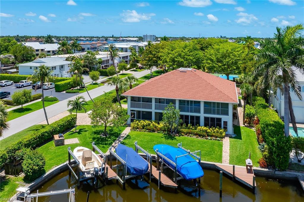 Experience the ultimate Naples lifestyle from this beautifully positioned two-bedroom, two-bath waterfront condominium offering deep-water direct Gulf access and your own private boat dock with lift, perfect for boating enthusiasts eager to explore Naples Bay, the Gulf and the area's pristine waterways. On the second floor, this light-filled residence enjoys an elevated setting with tranquil canal and marina views from the spacious screened lanai, creating the ideal place to relax with your morning coffee or unwind after a day on the water. A rare and desirable feature, the property also includes a dedicated detached garage, providing secure parking and additional storage. Ideally located just moments from the heart of downtown Naples, you'll enjoy easy access to the world-renowned dining, boutique shopping and vibrant galleries along Fifth Avenue South, as well as the sugar-white sands and breathtaking sunsets of Naples Beach. Whether you're searching for a seasonal retreat, a year-round residence, or an exceptional waterfront investment, this property offers the perfect combination of location, boating lifestyle and best of coastal Naples living.