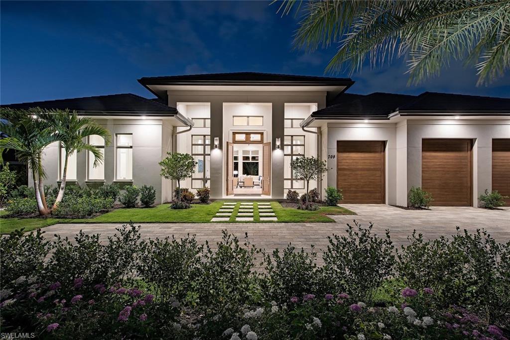 This newly constructed home situated right in the heart of the Moorings on a quiet street is an unsurpassed and prominent collaboration between distinguished builder Knauf Koenig, architect Falcon Design, and interior design firm Calusa Bay.  Residence is a truly remarkable transitional style home offering a generous and open single level layout spread across just over 4,600 square feet of air conditioned living space including 5 en suite bedrooms, 5 ½ baths, 3 car garage, and a seamlessly integrated resort like outdoor living area. Some of the special features include Gourmet kitchen with Wolf, Sub Zero, and Bosch appliances, service kitchen, Legno Bastone St Moritz wood flooring, Ruffino cabinetry, distinctive marble, quartzite, and stone throughout, extensive millwork, mahogany front/garage doors, and absolute top quality craftsmanship with no detail overlooked. The fully private, lush and tropical outdoor living space is adorned with heated pool/spa, oversized pool with sun shelf, and large covered outdoor living space complete with fire place, full outdoor kitchen with gas grill, and automated screen/shutter protection. Coveted Moorings private beach access available.