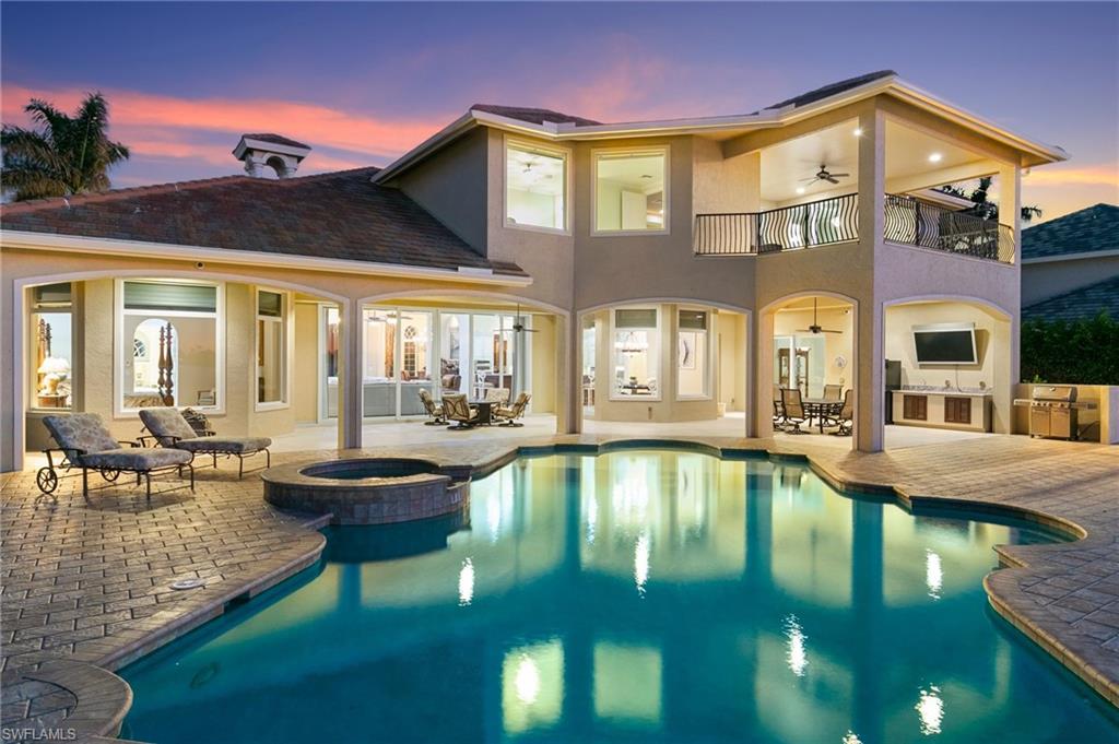 Discover the pinnacle of luxury living in this renowned Sunset Builder model, set on an oversized deep lot with an expansive outdoor oasis. With unobstructed bay views and breathtaking northwestern sunsets, this 4-bedroom + den, 4.5-bathroom masterpiece seamlessly blends timeless elegance with superior functionality. Boaters will love the direct Gulf access, 100 feet of water frontage, two boat slips, private boat lift, and jetski lift, while the resort-style pool and spa, summer kitchen, and fire pit create the perfect outdoor retreat. The circular driveway enhances curb appeal and convenience, leading to a 3-car garage with upper-level storage and lift. Inside, every detail reflects exceptional craftsmanship, from the open-concept living area with a wet bar and fireplace to the expansive covered balcony. Each bedroom features an ensuite bath, while the bonus loft area and home office provide added versatility. Built for peace of mind, this home includes hurricane-impact windows and doors, electric screens, a whole-house generator, and extra-high elevation. Fully furnished and located in a highly sought-after area, this residence offers the ultimate in refined waterfront living. Don’t miss this rare opportunity—schedule your private tour today!