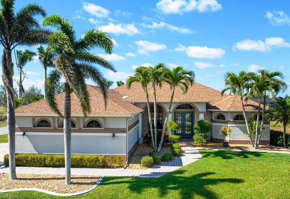 LOCATION, LOCATION, LOCATION! This 4 Bed Pool home is in one of the Cape's premiere neighborhoods with many Gulf Access homes. Plus it's adjacent to Joe Stonis Park providing you with pleasant scenery, walking paths, play areas, exercise equipment, and more at your doorstep. NEW ROOF! ASSESSMENTS PAID! Over 2,400 sq ft for you and your guests. Gourmet kitchen features Corian countertops, stainless appliances and a walk in pantry. Main living areas and master suite overlook the pool area. This home also features a formal dining room, and formal living room that would make a great office or study area if desired. The large family room and kitchen feature an open concept plan great for entertaining. The master suite has a private entry as well as sliding doors to the lanai. The master bathroom has dual sinks, a large soaking tub, separate shower, and private toilet room. The lanai has a 2nd area There are  brick pavers on the walkway, driveway, and lanai. The expansive lanai has a 2nd area behind the home for your grill keeping smoke away from guests and the pool. Garage & driveway are on the side of the home for easy parking & entry. The garage has an exhaust fan and cooling system.