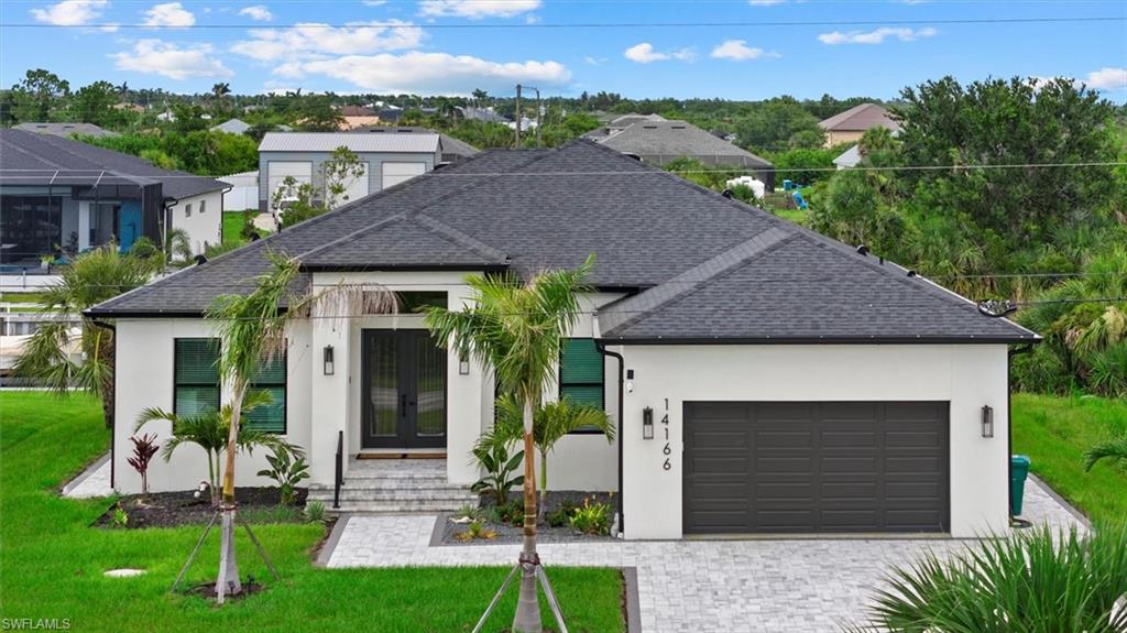 Located in the highly desirable South Gulf Cove Boating Community, this newly built 2024 WATERFRONT home with GULF ACCESS is move-in ready and offers modern coastal design with high-end finishes throughout. Featuring 4 bedrooms, 3 bathrooms, and 2,166 sq ft of living space, the home is constructed on a 4-course stem wall for added elevation and includes IMPACT WINDOWS AND DOORS throughout.

A grand entry with modern GLASS DOUBLE DOORS opens to a bright and airy interior showcasing SOARING CEILINGS, 8’ INTERIOR DOORS, and wood-look plank TILE flooring throughout. The open-concept layout creates seamless flow between the living, dining, and kitchen areas while maximizing natural light and canal views.

The chef’s kitchen features QUARTZ COUNTERTOPS with a WATERFALL island, soft-close cabinetry, and a WALK IN PANTRY with built-in shelving for added storage and function. The primary suite serves as a private retreat with spacious walk-in closets and a spa-inspired en-suite bath complete with designer tile, a DOUBLE VANITY, and a large TILED walk-in shower.

The split floor plan offers privacy, with two additional bedrooms positioned on the opposite side of the home, including one with its own en-suite bath—ideal for guests or multigenerational living.

Exterior highlights include a paver driveway, paver walkway surrounding the home, canal-fed irrigation system, and gutters throughout. Enjoy canal frontage with GULF ACCESS, providing direct access for boating, fishing, kayaking, and true Southwest Florida waterfront living.

South Gulf Cove offers an optional HOA of just $120 per year and is conveniently located near beaches, golf courses, shopping, dining, and some of the best fishing in Southwest Florida.