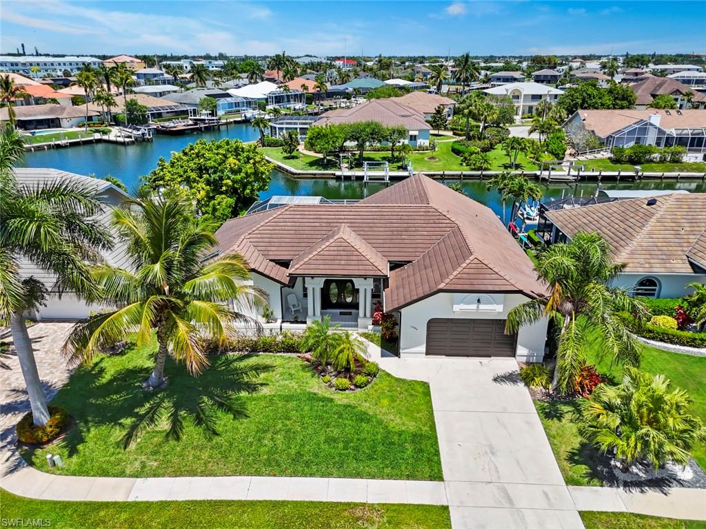 Must see in person to appreciate the wide water views! Experience the waterfront lifestyle you’ve been dreaming of in this exceptionally private Gulf-access home with stunning wide water views and no neighboring lanais in sight. From sunrise to sunset, the serene setting creates the perfect backdrop for relaxing by the oversized pool and spa while enjoying complete peace and privacy. 

Filled with natural light, this beautifully maintained residence is on quiet cul-de-sac and features expansive windows, sliding glass doors that pocket into the wall, and transom windows that showcase soaring volume ceilings and capture breathtaking water views throughout the main living areas. The open kitchen and dining space is designed for both comfort and functionality with soft-close cabinetry and drawers, pull-out shelving, and a new stainless steel refrigerator with ice maker. Turn-key furnished! 

The spacious primary suite offers a spa-like retreat with an updated bath featuring a soaking tub, walk-in shower, and dual-sink vanity. Additional updates include new A/C, updated plumbing and electrical systems, and a new pool pump, and new flat tile roof in 2018 for added peace of mind. Fully painted inside and out. New epoxy garage floor. And a fenced in yard for your dog!  Low transferable flood insurance currently $1,693.

Outdoor living is truly exceptional with a newly refurbished lanai wet bar complete with soft-close cabinetry, creating the ideal space for entertaining or unwinding after a day on the water. Boating enthusiasts will appreciate the private dock equipped with a boat lift and two Jet Ski lifts, plus quick Gulf access with just a 20-minute direct ride to open water. 

This rare waterfront opportunity combines privacy, comfort, and effortless boating access in one remarkable property. Biking distance to restaurants, Farmer's Market, Veteran's Park events, Esplanade & shopping, Mackle Park children's park, trails, dog park, & sports programs, pickleball & tennis. Minutes to Resident's Beach-$200/year offers parking, cafe, Chickee Huts, Grills & one of the best beaches in the world!