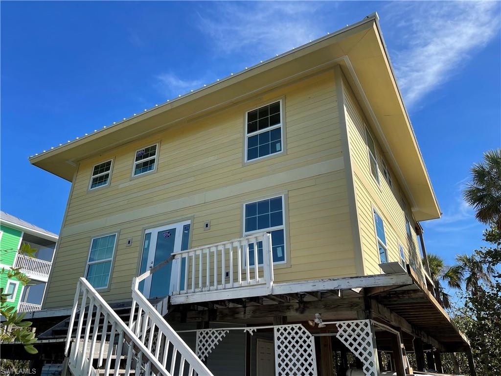 FANTASTIC North Captiva Investor or Dreamy Island Home Owner Opportunity! *Engineering plans for the remodel have now been completed 10/01/2025* Largest Available Beach Home at Best Price! Charming Large Olde Florida Style Beach Home with New Modernized Expansive Floor Plan with Tons of New Natural Light Plus 360 Degree Island Water Views! So Close to the Bay for World Class Fishing at Airstrip Beach and a Short Ride to Butterfly Beach with World Class Shelling and the Islands Amazing State Preserve! This home has Beautiful Water Views from the Third Level Balcony and Over 2148 Newly Framed and Structured SQ Feet! The Current Foot Print is Four Fantastic Bedrooms and Three Full Baths. Welcoming Entry Foyer with Glass Front Door with Side Panels and Lovely Oak Staircase. Beautiful New PGT Hurricane Impact Windows Throughout, Exterior Doors, and Multiple Sets of PGT French Doors. Brand New White Metal Standing Seem Roof. New Hardi Board Siding on Whole House excluding ground level. AMAZING New Built Cupola Ceiling and Windows! New Interior Framing. All New Rear and Side Decks - mostly finished. Wrap Around Decks for Finishing. Huge Oversized Bright Remodeled Kitchen with Pantry and Window Lined for Views that overlooks the Dining Area and Living Room with French Doors out to the Second Floor Balcony. Added Tray Ceiling in the Dining Room. There are Three Large Balconies which were also restructured.  New Weardeck High End Composite Decking on First Level Balcony. One is accessible from the First Level of the Home, one is accessible from the Second Level and the Third will be accessible from the Second Level Balcony upon an exterior staircase installation. Lookout Balcony with Gulf and Bay Views! Large Laundry/Storage RM in place. Under House Storage Room/Garage. North Captiva Island is known for Pristine Gulf and Bay Beaches, Beautiful Waters, Amazing Marine & Wildlife, State Preserve, World Class Fishing & Shelling. This Beach Home is in the process of being rebuilt. New Buyers to finish construction items to make this Island Home Your Own! Being sold As Is. Engineering Plans in Hand and to be provided to the Buyers for Remodel. Great Opportunity!