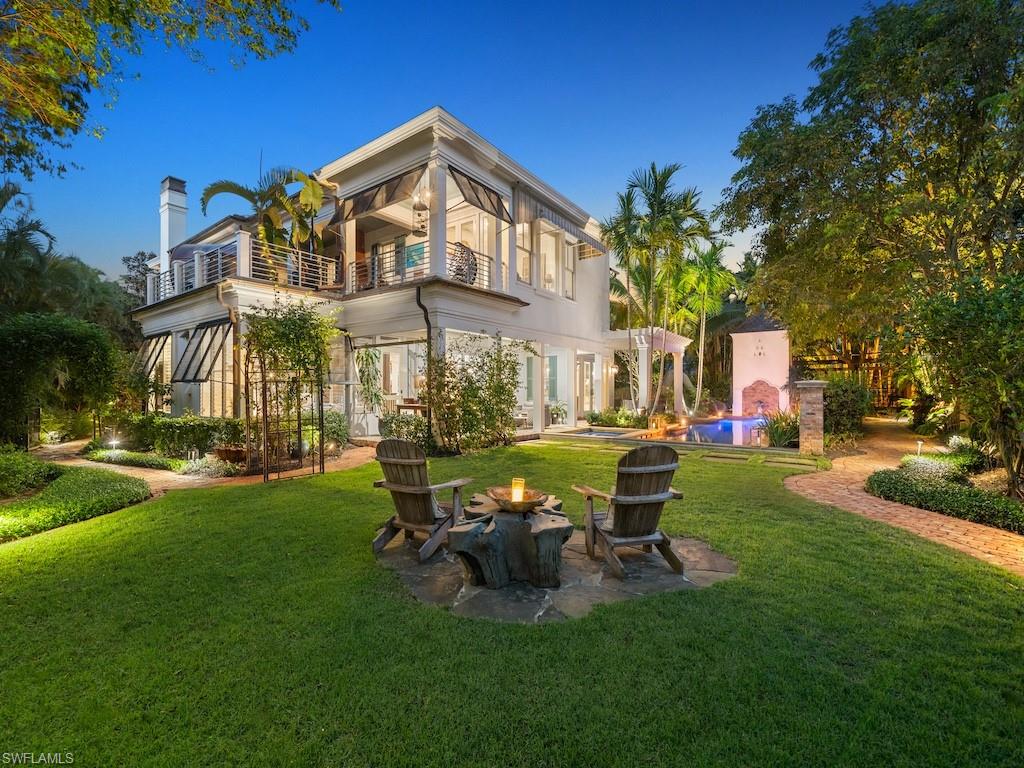Situated on an oversized lot within 2 blocks to the beach, this quality-built plantation style home offers sophistication and style. Encompassing 5 bedrooms, office, den and a private guest casita with kitchenette and separate access, the layout is ideal for lifestyles of all kinds.  Enter in from the charming covered front porch and be greeted by a 2-story foyer with grand staircase and custom molding, providing an elegant yet comfortable feel. Just down the hallway, past the formal dining room is the recently refreshed kitchen including an oversized island with prep sink, stainless Wolf appliances, lots of counter space and a bar niche complete with wine tower and more. The Florida room is where all the time will be spent, lined with glass to bring the outside in and featuring a traditional fireplace for the perfect atmosphere. Guests will feel right at home with the spacious guest rooms while residents enjoy the seclusion of an upstairs primary bedroom with dedicated covered and uncovered balcony space.  The outdoor area is a blast currently with zip line, water slide, tree house and more but also provides ample additional space to make it your own.  Rich with character, intricate details and quality craftsmanship, this Art Canada constructed home is one you must see. On the northern end of Olde Naples, the location is ideally private but also a quick stroll to what will be the Naples Four Seasons, 5th Ave, 3rd St and so much more.