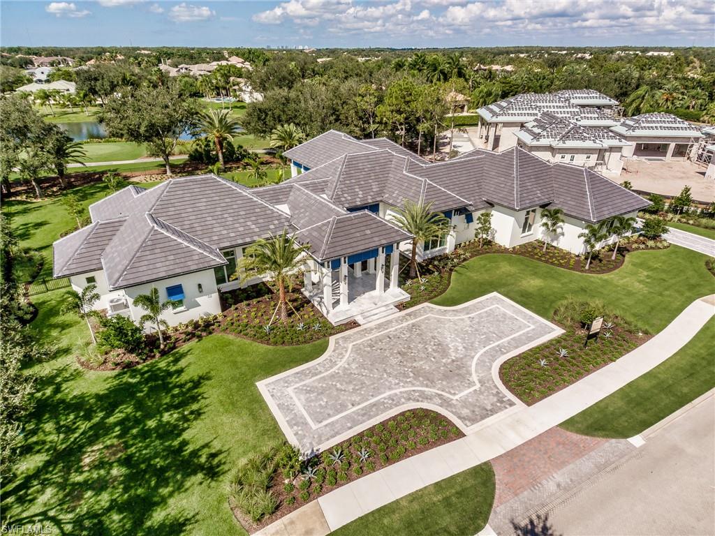 Sold price = $4,050,000 + $350,000 furniture package.  Diamond Custom Homes presents the Ladera, their expertly appointed furnished model. Among a scenic landscape of lake, golf & sunset views, this near-acre lot is one of the best available sites in Quail West. The West Indies-style floor plan, designed to fit your state of mind and entertain your guests, features 4 bedrooms, study/club room, and 5 full baths plus 2 powder rooms in 5,568 s.f. under air and 7,854 total s.f. All your senses are engaged as you enter the parlor overlooking bubbling fountains, custom designed pool, enticing spa, and artful landscape. Indoors, the formal dining area boasts three wine coolers, chef-inspired kitchen with premium appliances, custom cabinetry & breakfast bar. The privately located master suite features elegant, separated bath suites & oversize closets. The club room could also serve as a den or media room & is anchored by a full bar. On the right side of the home is a separate VIP suite w/private access to the outdoor living areas. 2 additional bedroom suites are positioned next to the laundry room, which leads to the motor court with 3 side-load garage spaces &designated golf cart space.