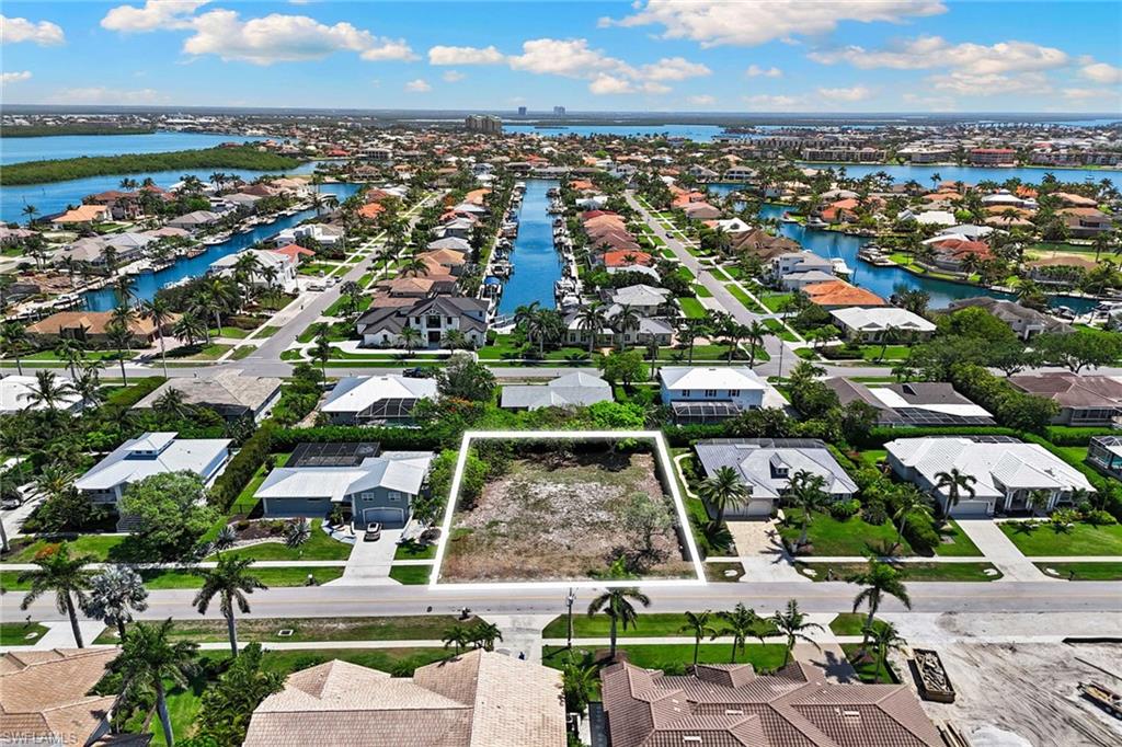 Welcome to the Tigertail Beach area of Marco Island, a sought-after destination for those seeking the ideal blend of tranquility and convenience. This stunning 0.25-acre residential lot offers an exceptional opportunity to create your dream home in a peaceful neighborhood setting. In a quiet community, you'll experience the serenity and relaxation that island living provides. Just minutes from beautiful sandy beaches, and the vibrant Esplanade shopping and dining area, offering a variety of restaurants, shops and entertainment options.