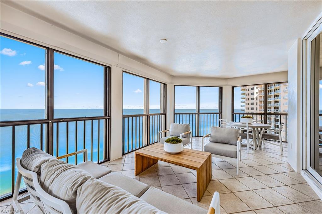 Gorgeous high-floor gulf views! This bright and open with three bedrooms plus den, and 3.5 baths is an ideally positioned high-floor end unit, featuring panoramic, oversized windows with tons of natural light and two expansive wraparound screened-in lanais with electric storm shutter protection. The outdoor spaces are exceptionally wide and spacious, ideal for sunset relaxation and entertaining year-round. The primary suite and guest bedrooms are on opposite ends of the residence to ensure maximum privacy and comfort. Just part of the Carlysle's appeal is the charm of its entry and welcoming lobby. The Carlysle elevator hallways have been updated. Private Bay Colony Beach Club, tennis club and all the Pelican Bay amenities are available to be enjoyed by residents.