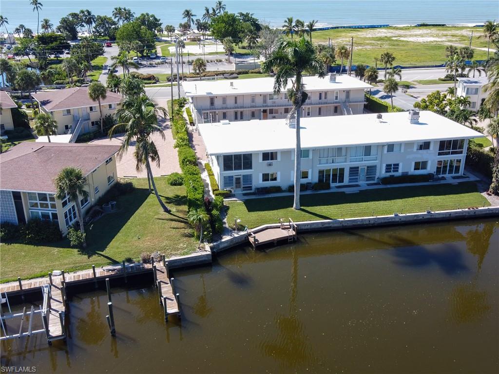 Paradise awaits in this second floor end corner unit in Lago Mar, just steps from the sugar sands of Lowdermilk Beach Park! This desirable unit offers more privacy, extra windows for natural light, and gorgeous unobstructed views of the bay from almost every room. It was also not damaged by Hurricane Ian. The co-op land lease complex is located in the desirable Olde Naples neighborhood, just a leisurely 10-minute bike ride to the Naples Pier, 5th Avenue restaurants, and 3rd Street shopping. The unit features a private laundry room off the kitchen with extra storage for bikes or beach chairs. Amenities include a fishing pier, boat tie-up, and kayak access to the Gulf of Mexico via Doctors Pass. Don't miss out on this opportunity to own one of the most desirable units in Lago Mar! This unit suffered no damage or water from hurricane Ian.