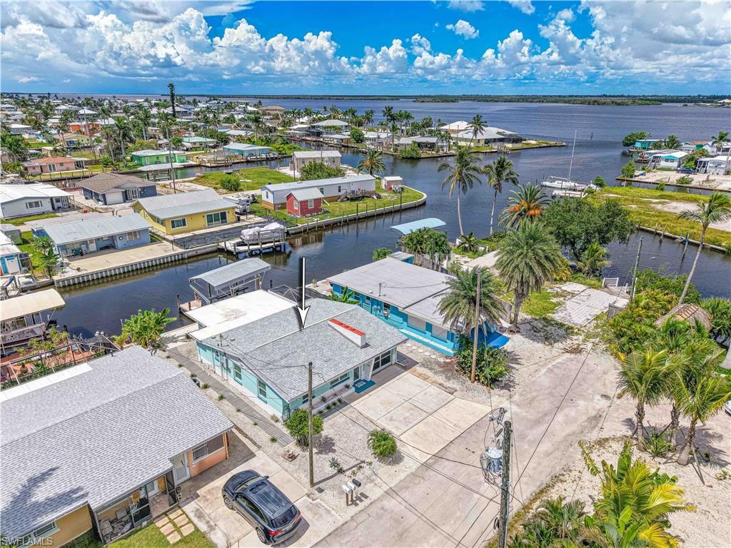 Own a Piece of Waterfront Paradise on Matlacha Island! This is a fisherman's dream just minutes from open water !

Welcome to island living at its finest! This beautiful 2-bedroom, 1.5-bath waterfront home offers direct Gulf access with no bridges—a true dream for boating and fishing enthusiasts. Located in the heart of vibrant Matlacha, this charming property is ideal as a full-time island retreat or a relaxing second home.

Step out your back door to your private boat lift with a protective canopy, making it easy to hit the water anytime while keeping your vessel safe from the elements. Whether you're heading out for a day of fishing or a sunset cruise, your boating lifestyle starts right here.

Inside, enjoy a cozy and open layout designed for easy coastal living. Outside, you're just minutes from local dining, shopping, art galleries, and live entertainment—everything that makes Matlacha one of Southwest Florida’s most beloved island communities.

Don’t miss this rare opportunity to own true waterfront paradise with direct access to open water and premium boating features. Schedule your private showing today and start living the island life! This home has Impact windows and doors, New roof in 2021, Screen enclosure and screened carport 2022