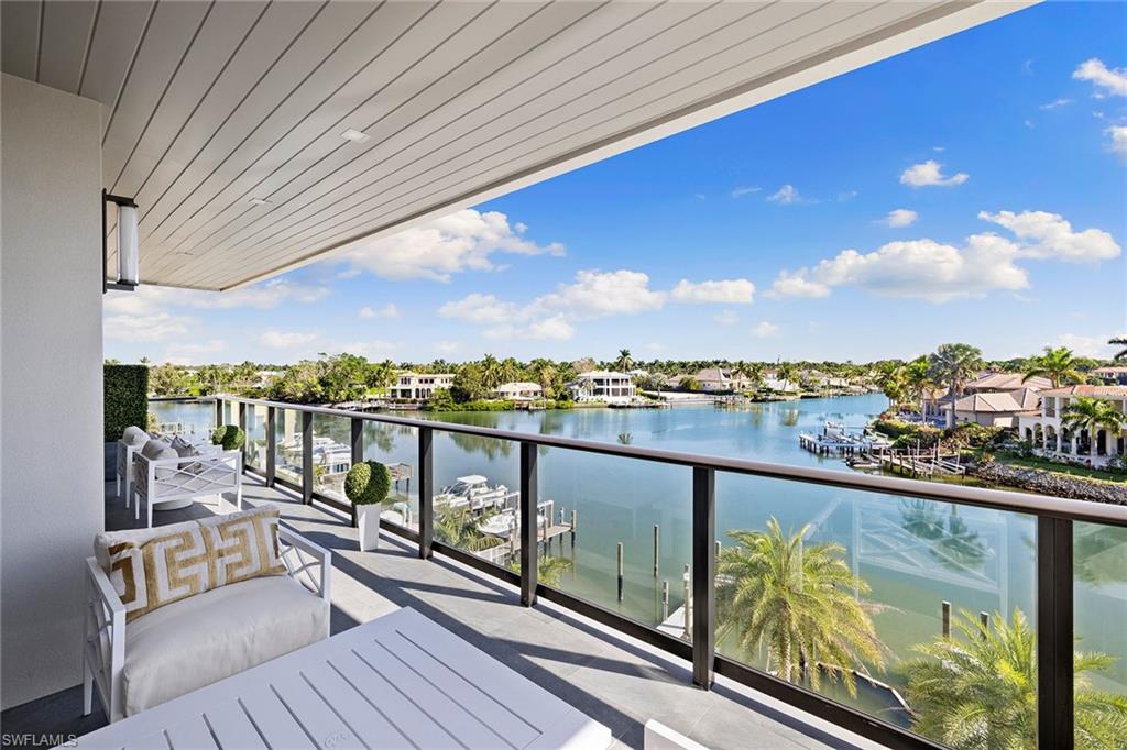 Step into a world of elegance and sophistication in this extraordinary waterfront penthouse. Decorated by Wilfredo Emanuel Designs, this condominium showcases an open floor plan, creating a seamless flow throughout. The gourmet kitchen features an oversized island, luxury appliances, custom cabinetry and lighting; it's a culinary haven. A well-appointed wet bar and dining area enhance the entertaining experience, and the great room is a versatile space ideal for relaxation, capturing both water and city vistas, leading onto the open lanai with Hurricane Harbor water views. The primary suite is a private retreat, complete with a luxury bath and generous custom walk-in closet, plus two additional en-suite guest bedrooms, powder room and laundry. This property, completed in late 2023, boasts its own boat slip on-premise, providing quick and easy access to the Gulf. Enjoy leisure activities like a waterfront putting green, relax by the resort pool or enjoy the rooftop lounge to take in sunsets. The beach, conveniently across the street, adds another layer of leisure. Located minutes to 5th Avenue South to enjoy fine dining and entertainment and walking distance to the fabulous upcoming Four Seasons Resort. Boat Slip # 9 included with purchase.