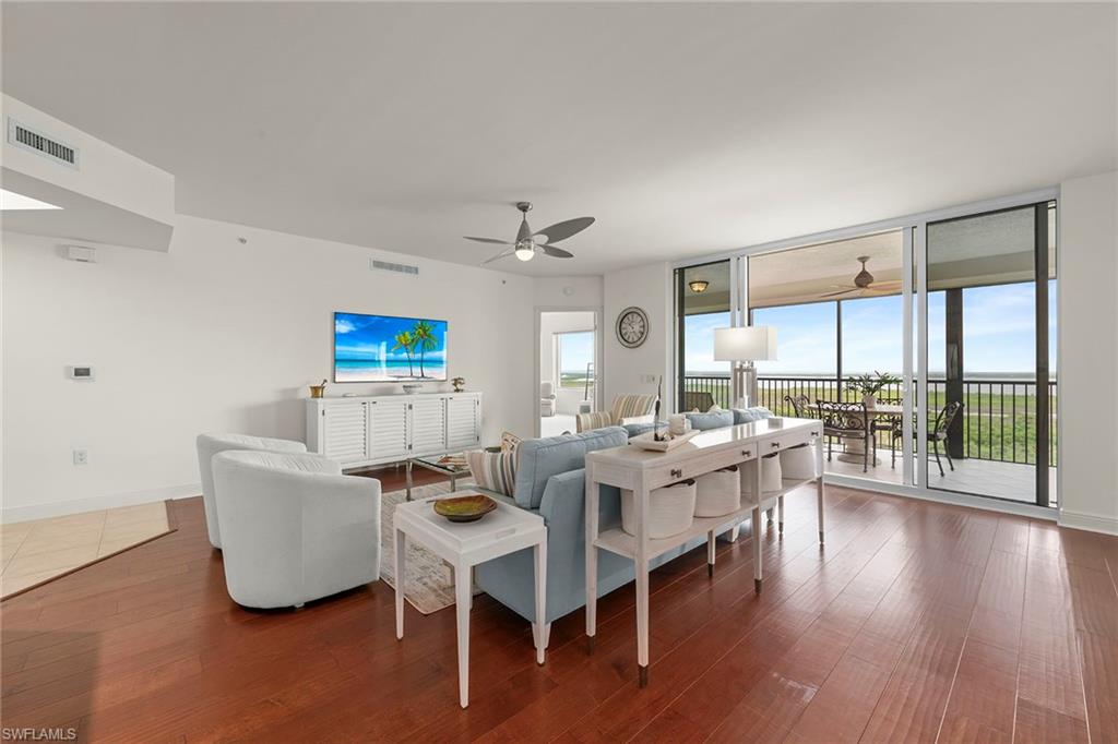 One or more photo(s) has been virtually staged, AI generated or rendered.  Experience elevated coastal living in this spacious great-room-style residence, positioned on the 15th floor to showcase breathtaking water and golf course views framed by Southwest Florida’s stunning natural beauty. This well-appointed home features three bedrooms, three full baths, a dedicated garage parking space and a private storage closet. Relax and entertain on the expansive tiled lanai, where panoramic views create the ideal backdrop. The open-concept kitchen is beautifully designed with granite countertops, rich wood cabinetry and flooring, stainless steel appliances, a breakfast bar and a pantry. Additional highlights include automatic hurricane shutters and a luxurious primary suite with lanai access and dual walk-in closets. The spa-inspired primary bath offers a soaking tub, dual vanities and a separate shower. Residents of Navona enjoy exceptional resort-style amenities, including a heated pool and spa, a cabana lounge, a sun deck, a social room, a private movie theater, two guest suites and a state-of-the-art fitness center. Residents of The Colony enjoy exclusive access to The Bay Club, featuring private waterfront dining and a secluded beach island accessible by a short scenic boat ride. Convenient shopping and dining options are just minutes away at Coconut Point, while Southwest Florida International Airport is approximately 30 minutes from the community. Embrace an exceptional lifestyle with included amenities such as a private island beach, fitness center, tennis, pickleball, bocce, canoe and kayak park, and more, all available with no additional membership fees. For golf enthusiasts, two championship golf courses offer optional memberships. Find out more by contacting the membership director for pricing and availability.