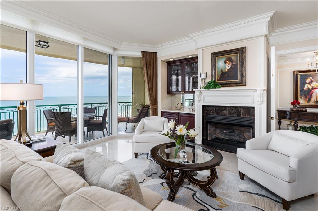 Fantastic opportunity to own a luxurious condominium at the Veracruz in prestigious  Cape Marco.  Truly an island paradise, this gorgeous residence offers total luxury with amazing views of the entire Marco Beach, Gulf of Mexico and the 10,000 Islands from both west and east facing balconies.  Enjoy sunrise over the Island and sunset over the Gulf every day of the year!  Enter this spacious 3 bedroom, 3 ½ bath condo home with your private elevator lobby and 10 ft. ceilings . Professionally decorated with gas fireplace, wet bar, quality furniture and marble flooring.  The gourmet kitchen offers gorgeous natural Taj Mahal quartzite,  and the finest appliances including 6 burner gas range and SubZero refrigerator.  Marco Island's premier building offers amenities galore including a gorgeous entrance and lobby,  luxurious social room and bar areas, billiards, movie theater, fitness center, two pools, sauna, outdoor grilling area, extra storage, two assigned garage parking spaces, and guest suites.  Cape Marco adds a community Fitness Center,6 Har Tru tennis courts, private beach access, and secure 24 hour guard gate with spectacular entrance and fountain. Furnished per inventory.