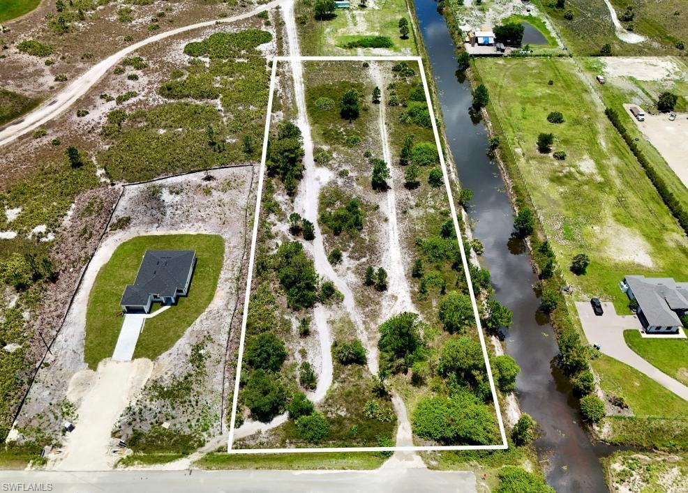 Exceptional opportunity to own 3.56 acres in the rapidly growing Golden Gate Estates area of Naples! This offering includes two combined parcels (Parcel IDs: 38721400003 & 387213600004), providing ample space to build your dream home, guest house, workshop, or equestrian retreat while enjoying privacy and no HOA restrictions. The property features canal frontage and offers convenient access to shopping, dining, schools, and the beautiful Gulf beaches. Utilities: Private well and septic required (no public water or sewer available). Buyers should verify zoning, environmental, wetlands, and building requirements during due diligence.