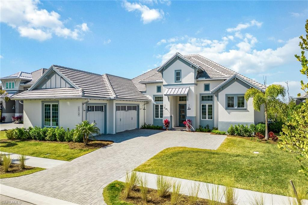 A newly built masterpiece on a quiet cul-de-sac street in the new exclusive gated community of the prestigious Isles of Collier Preserve. This exquisite property offers 3,578 square feet of sophisticated living space, comprising four bedrooms, a den and 4.5-baths. As you approach, the wide paver driveway gracefully leads you to a three-car garage with epoxy flooring, setting the stage for the home’s striking tile roof with metal accents, and impact-resistant doors and windows. The lush preserve and mangrove backdrop with southwestern views is ideally framed by an expansive picture window screen enclosure. This outdoor oasis features a gas-heated saltwater pool and spa, covered area with coffered ceiling, a built-in gas fireplace and an outdoor kitchen with gas grill, granite countertops, and a large center island for endless relaxation and entertainment while enjoying stunning sunsets. Inside, the awe-inspiring 14-foot ceilings, adorned with crown molding, smooth coat walls and ceilings, recessed lighting, open floor plan and in-ceiling speakers amplify the grandeur. The foyer welcomes with museum-style double glass doors, while the den with its tray ceiling and glass French doors offers a tranquil retreat. The living room with pocketing 10-foot sliders that join the inside with the outdoors, is accentuated by a stunning beamed ceiling with a designer chandelier, seamlessly flowing into the gourmet kitchen. Here, pristine shaker-style cabinets with underlighting, quartz countertops, Carrara marble backsplash, grand center island, walk-in pantry, and new KitchenAid appliances, including a five-burner gas cooktop, await culinary exploration, together with the breakfast area overlooking the pool. The formal dining room, with its coffered ceiling, basks in natural light, setting a picturesque scene for gatherings. The owner’s suite features pool views, tray volume ceiling, two walk-in closets, private lanai access, and a spa-like en-suite bath with dual sinks, framed mirrors and large walk-in shower. All three guest bedrooms are en suite with private baths for each room and on the opposite side of the home as the primary for privacy. Additional highlights include designer lighting, two Trane HVACs, instant hot water and a 500-gallon propane tank. Oversized laundry room with plenty of storage and counter space, and sink. Enjoy a new Stock-built Marigold floor plan home with high-quality features but without dealing with the hassles of the building and punch-out process. The Isles of Collier Preserve residents enjoy a gated entrance, resort-style and lap pools with cabanas, clubhouse, restaurant, fitness and wellness center, sauna, dining, dock with kayak launch, and courts for tennis, pickleball and bocce. Just 10 minutes from downtown Naples, this home is a gateway to a lifestyle of unparalleled luxury.