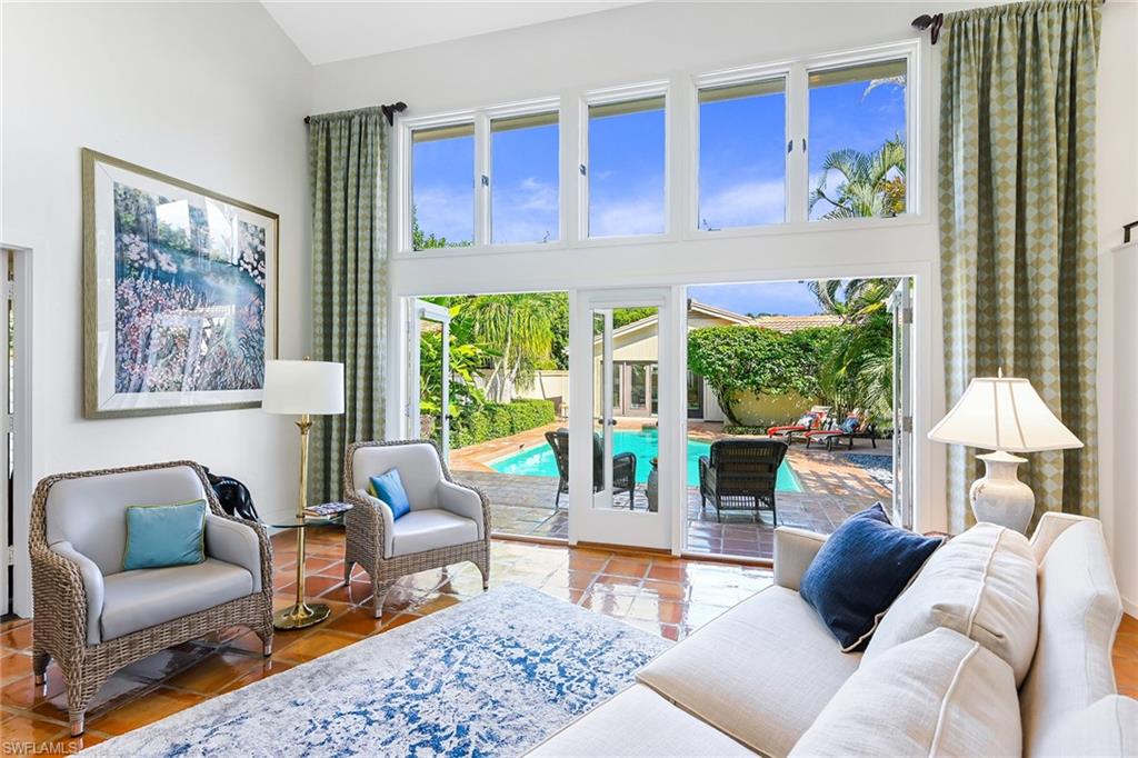 Welcome to your own private oasis, boasting .46 acres of peace and quiet inside the exclusive Pelican Woods neighborhood of Pelican Bay. As you walk through the entry gate, you are met by an expansive courtyard and sun-sparkling pool — making this home the ideal retreat for relaxing or lively entertaining. Perfectly designed for Florida living, this 5-bedroom, 4.5-bath home offers open flowing rooms and light streaming from soaring ceilings, dramatic windows and glass doors, providing access to the lush, beautiful grounds from every room. Built in 1980 and impeccably maintained, the main home has generous living spaces and an oversized owner's suite as the perfect retreat. Family and guests will enjoy resort-like accommodations while using the spacious Cabana built in 2016, offering independent living. A 3-car garage with electric charger and enclosed side yard for your dog provides all the practical benefits for modern living. Amenity-rich Pelican Bay offers private beach clubs with dining, tennis, golf and world-class fitness. Ideally situated in walking distance to Artis—Naples, Waterside Shops and white sand beaches of the Gulf. Your perfect Naples destination awaits.