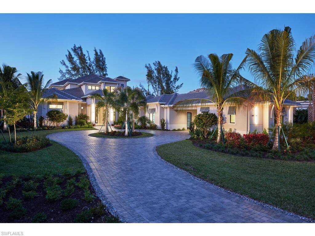 The St.Lucia Model is a rare find for the discerning Naples homebuyer. Built by McGarvey Custom Homes, an award winning builder known for their unwavering commitment to detail and a white glove approach to service, this fully furnished residence continues their legacy of developing luxury properties of the finest quality in materials and design. Upon entry, the expansive great room reveals McGarvey's signature "floating" ceilings, a glass staircase, and a wine bar. There are 4 bedrooms in the main home and attached 5th bedroom/guest wing that has its own bath, kitchen, and living room. The second floor houses a bonus room with a pool table and private balcony, and master bedroom boasts floor-to-ceiling widows on on three sides which overlook the lake. The modern gourmet kitchen includes frameless wood cabinetry with soft close hinges, and WOLF & SUBZERO appliances. Wall-to-wall glass sliding doors open completely to the exceptional outdoor living which includes an outdoor kitchen, fireplace, pool, spa & fire pit oriented to the lake.