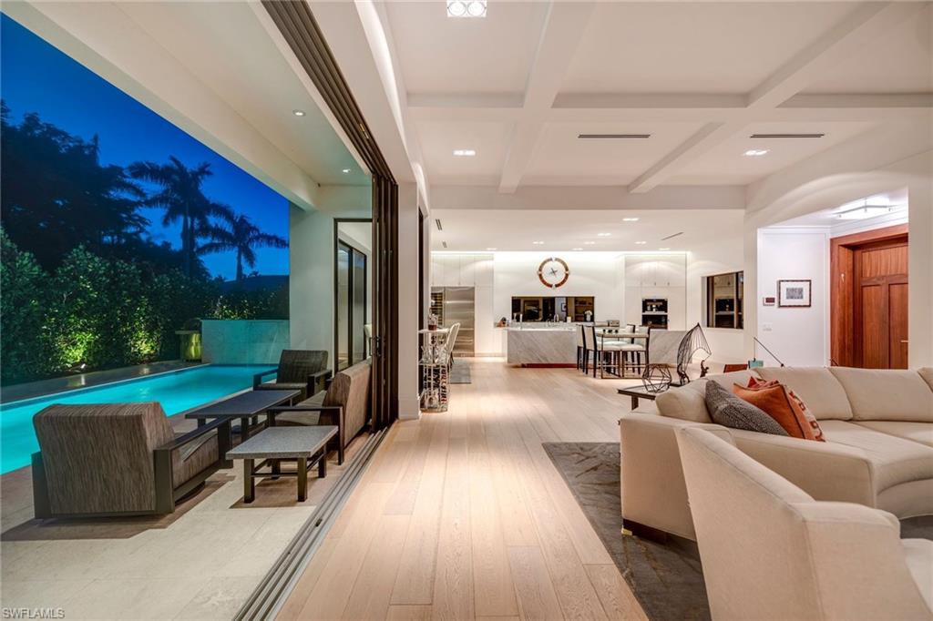 Urban Oasis located in the real heart of Olde Naples, this magnificent southern exposure 2-story property is ideally situated within 3-blocks of the beach. This stunning 3 Bedroom + Study or 4th first-floor bedroom, 4 bath residence revives the quintessential of Old Naples with a bold infusion of chic and casual elegance. High ceilings dominate the open floor plan bathed in abundant light. Thoughtfully appointed finishes include wide-plank flooring, Carrara marble, a fabulous chef’s kitchen, and white beamed ceiling treatments. The large gourmet kitchen features a 16 feet long island with waterfall Carrara marble countertops, Sub Zero fridge and Wolf appliances, double wine cooler, Cappuccino maker, cook-top with pop up vent and custom solid white wood shaker cabinets. Entertain with ease with an open concept floor plan that transitions seamlessly to stunning outdoor spaces. Embrace the Florida lifestyle from this home’s outdoor living area with pool and spa. This Old Naples home encompasses an unparalleled combination of location, quality, and finishes. A Mastery of Architecture & Craftsmanship. Agents see remarks.